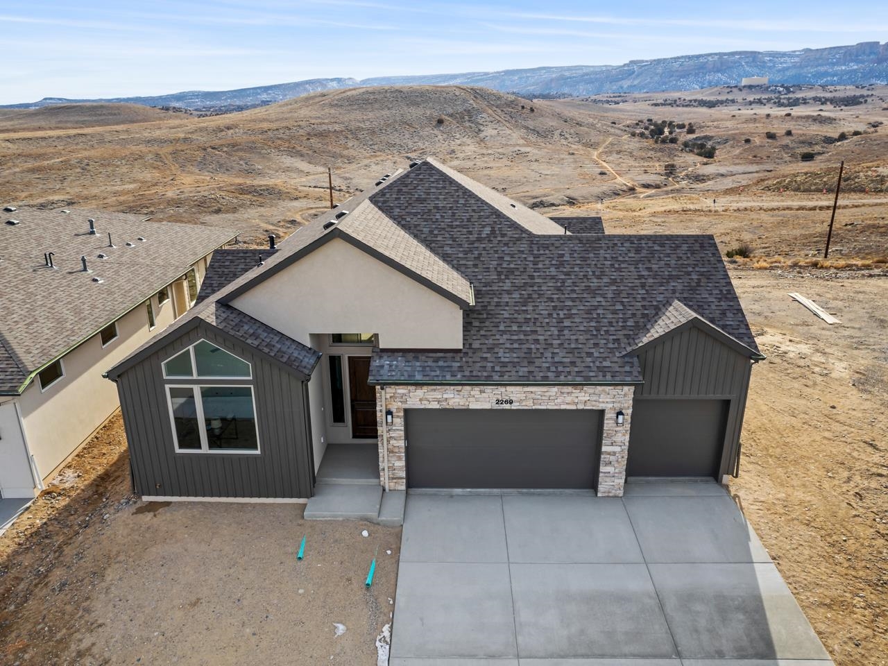 We are excited to announce that the award-winning builder, with over 35 years experience, Goetzmann Custom Homes, is building in Grand Junction. Come visit our model home in the Easter Hill community of Redlands 360. This particular home is currently under construction, and is perched on a bench, offering views of the beautiful surrounding areas. Features of the home will include a gas line to grill on the back patio, under cabinet lights in kitchen, A/C, whole house fan, aluminum framed mirrors in primary bath, additional wall bar adjacent to Great Room. Additionally there is upgraded carpet throughout, solid surface countertops in the kitchen with upgraded backsplash tile, trash pullout in the kitchen island, gas fireplace in the Great room, a painted bench with coat hooks in the Owner’s Entry. The neighborhood, Redlands 360,  encompasses more than 600 acres and will feature open space and a variety of trial systems. Literally, the trail system is just footsteps out the backdoor. Ready for your next mountain bike adventure, hiking excursion or simply taking your dog out for a quick walk? You can not beat this location for enjoying the vast terrain and stunning views. Beautiful open concept, offers phenomenal views of Easter Hill and the stunning National Monument. Contact listing agent for details on other available lots and homes in this neighborhood, and visit our model home just down the street from this location.