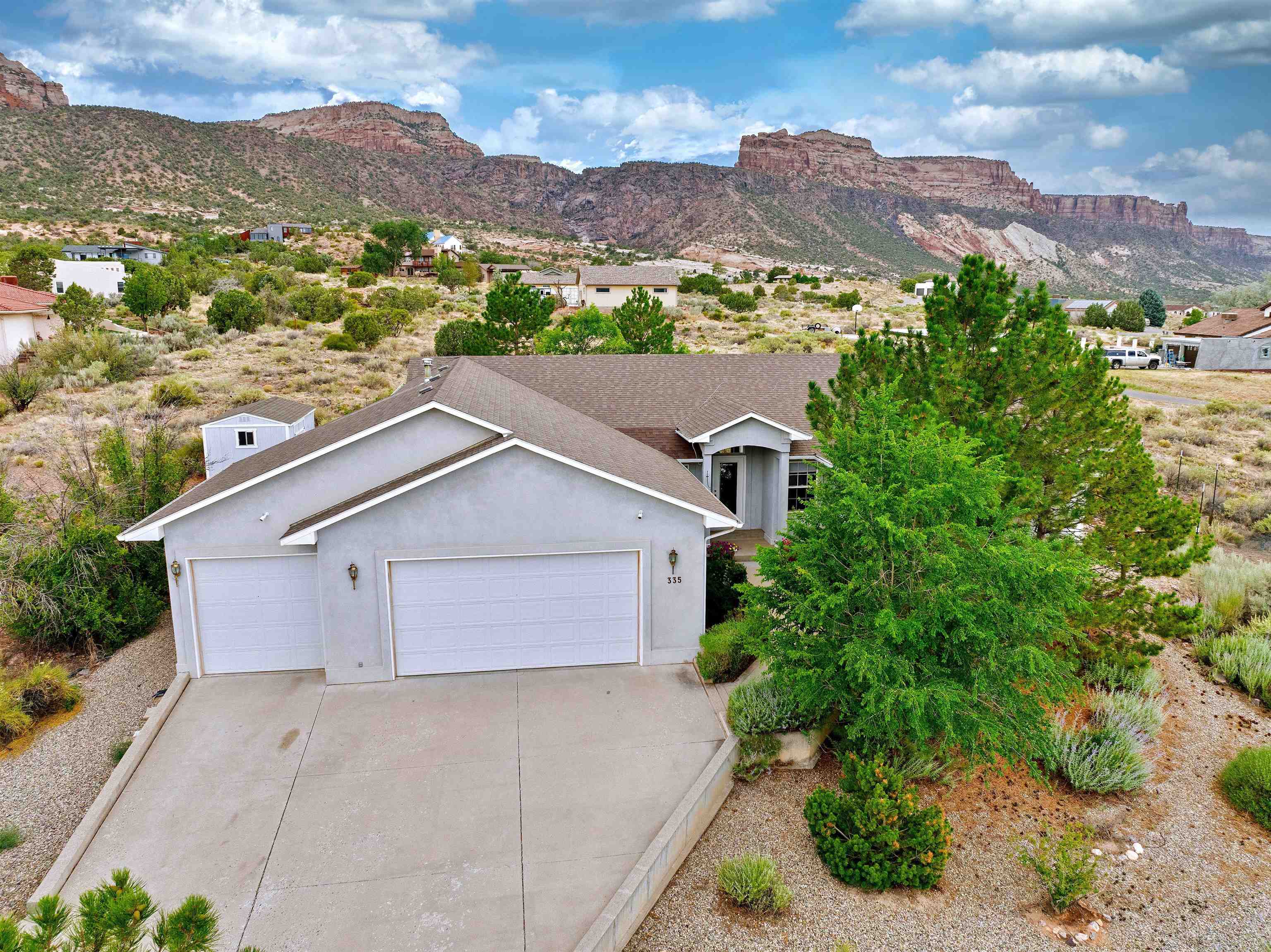 Tranquil setting with fantastic views of the Colorado National Monument, 2447 s.f, 4 bedrooms, 3 bathrooms, refrigerated air, and programable thermostat; plus,  if you choose, you also have baseboard hot water heat. RV parking and a spacious 3 car garage. Drip system for the front door potted plants, plus trees, a garden area, and workshop shed. The office could also be a 5th bedroom (no closet) or formal dining room. This home is close to hiking and biking trails, and Tiara Rado Golf course.