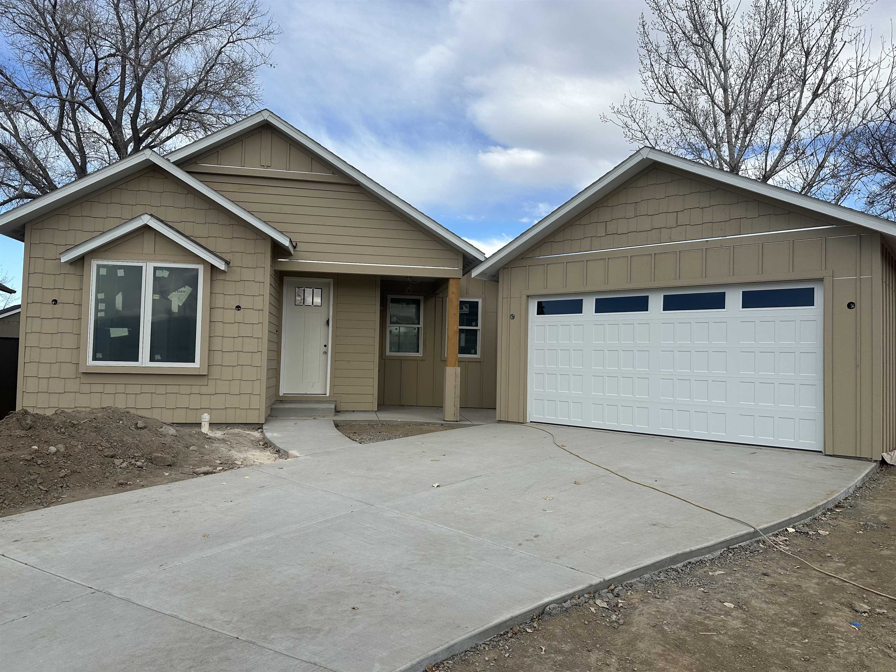 New construction with an ADU near the heart of downtown Fruita now available! Main home offers 3 bedrooms and 2 bathrooms, and the ADU has an additional bedroom and bathroom. The functional and well-designed floorplan features high ceilings, tall doors, and an open concept living space that combine to make the home feel larger than its footprint.  Enjoy preparing meals in the beautiful kitchen featuring a gas range, quartz countertops, soft-close cabinets, stainless appliances and a pantry. Cozy up in the living room with an electric fireplace and large windows for plenty of natural light. The primary suite has a walk-in closet and a bathroom with double sinks and a step-in shower. The detached garage/ADU has 1 bedroom, 1 bathroom, kitchen, washer/dryer hookups and a private entrance that would make a great rental unit, guest house or in-law suite. Front landscaping and custom steel fencing are included in the price. Total approximate square footage includes ADU.