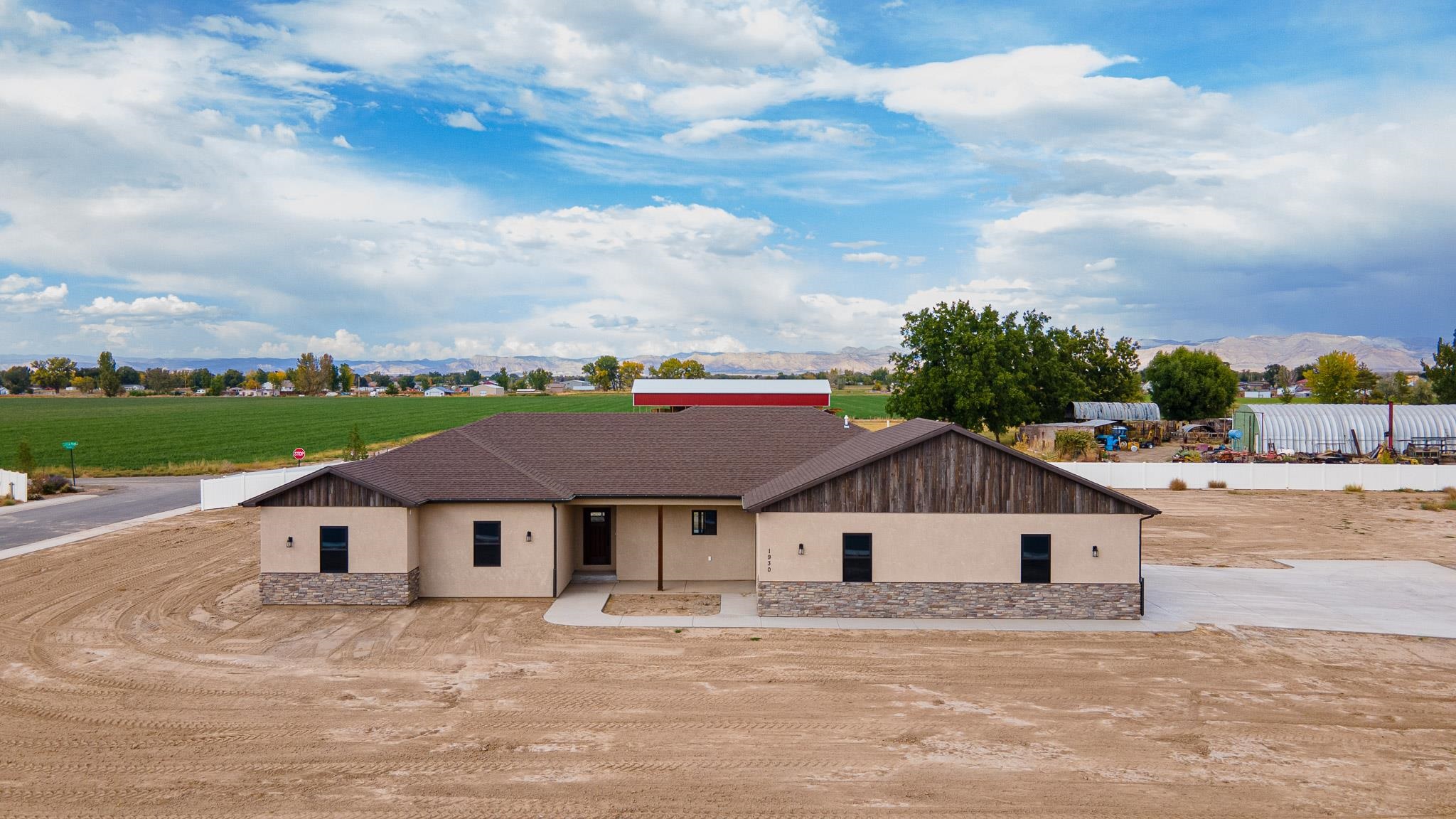 Gorgeous new build by Don Vidmar. This stucco and stone home is located in the Palmer Subdivision just outside of Fruita with convenient access to mountain biking trails, summer festivals, hospitals, shopping, river sports and much more. Come see this home with 2 primary suites for a total of 4 bedrooms, 3 bathrooms, a 3 car garage with an EV charging port. Inside are granite counters, Alder soft close cabinets, tile bathrooms and laundry, wood laminate and carpet flooring, walk in closets and walk in showers. This home is energy efficient with R24 blown in insulation in all the exterior walls and sports Frigidaire appliances.  Home is nearly complete and builder is willing to let buyer decide what type of mirrors they want in the bathrooms. Seller is motivated and willing to consider a credit for landscaping.