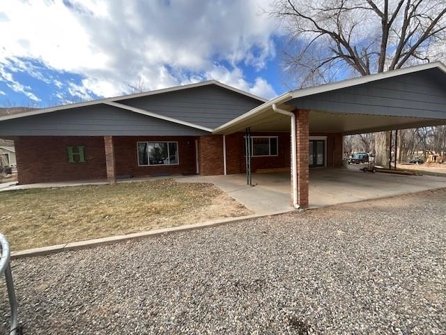 Nestled under the Colorado National Monument, with end-of-the-road privacy, awaits this Redlands gem.  This brick, 3 bedroom, 3 bath, 2 story, 3028 sq ft home has great potential as it sits in one of Grand Junction's premier locations.  Every window has a view, and every blade of grass has a timed sprinkler set to water it, even the pastures.  Easy access to the Colorado National Monument is right out your back door, where you can enjoy hiking and rock climbing.  It's close to Tiara Golf course and numerous mountain bike trails.  The large shop can be used for cars, home offices, or workspace.  This home offers RV parking, and 4.29 acres of peaceful tranquility, beautiful views, wildlife, and endless possibilities.