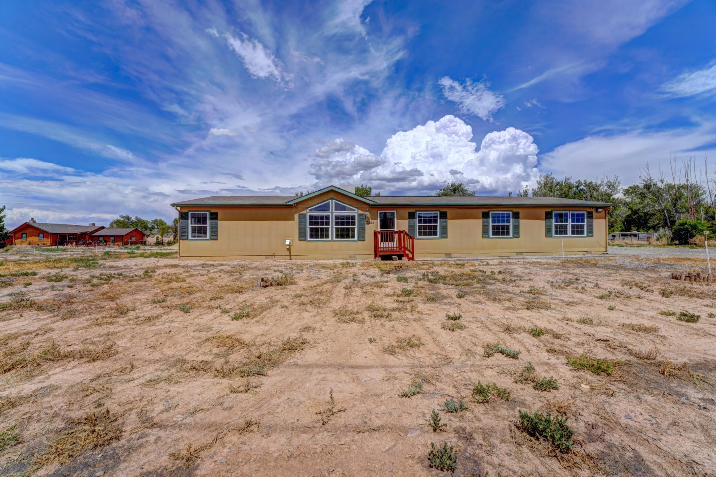 PRICED TO SELL! Welcome home on 1.2 acres! This clean 4-bedroom, 2-bathroom home with new LVT flooring, new paint and carpet offers beautiful views of the National Monument from every front window! Enjoy cozy evenings in the living room with a pellet stove or spread out in the huge family room to make memories. The bright eat-in kitchen features ample cabinets, serving sideboard and pantry. Relax on the covered back porch, or step inside and enjoy the option of A/C or evaporative cooler. Plus, there is no HOA to dictate how to enjoy your castle! This property is perfect for those seeking tranquility and breathtaking scenery. GVIC irrigation is available and shares can be bought or rented. Mesa County zoning permits an additional ADU (up to 1500 sq ft) can be built on this lot too.