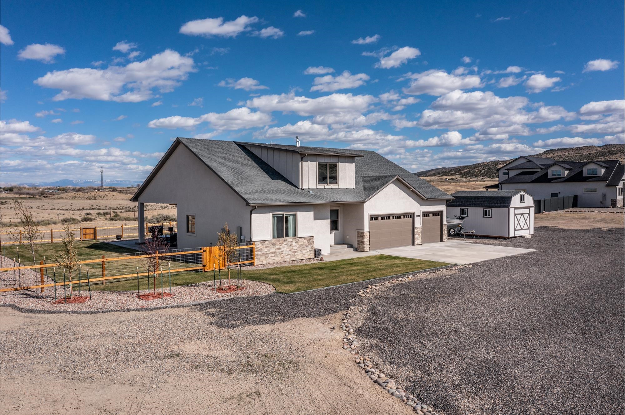 Welcome to quite country living!  This attractive Builders-personalized home was built in 2021 in Ruby Canyon Estates. From the front porch or the back patio, you’ll enjoy 360-degree views of every sunrise and sunset.    On the main level there are 3 bedrooms and 2 bathrooms, 10’ ceilings, all LED lighting, ceiling fans in all rooms, 8’ solid wood doors, granite and quartz countertops throughout, soft close cabinets throughout, hot water recirculation pump for instant hot water, spacious master shower, electric fireplace, dual fuel range/oven, large laundry room and multiple storage closets.  In the upstairs bonus suite, you’ll appreciate the view and the privacy of a large bedroom complete with its own attached full bathroom and walk-in closet.    Outside you will find 12’ garage ceilings with built in storage and epoxied garage floors, a 14’x20’ shed building, ample trailer, boat and RV parking with a dedicated 50-amp RV outlet and designated sewer cleanout, 50-amp hot tub outlet, 400-amp electrical service for your future shop, an in-ground 1,000-gallon propane tank, and a fully fenced, irrigated and landscaped yard, with designated garden area, and full access to the private Lake for homeowners and their guests.   There so much more to see with this property to fully appreciate how excellent it is.