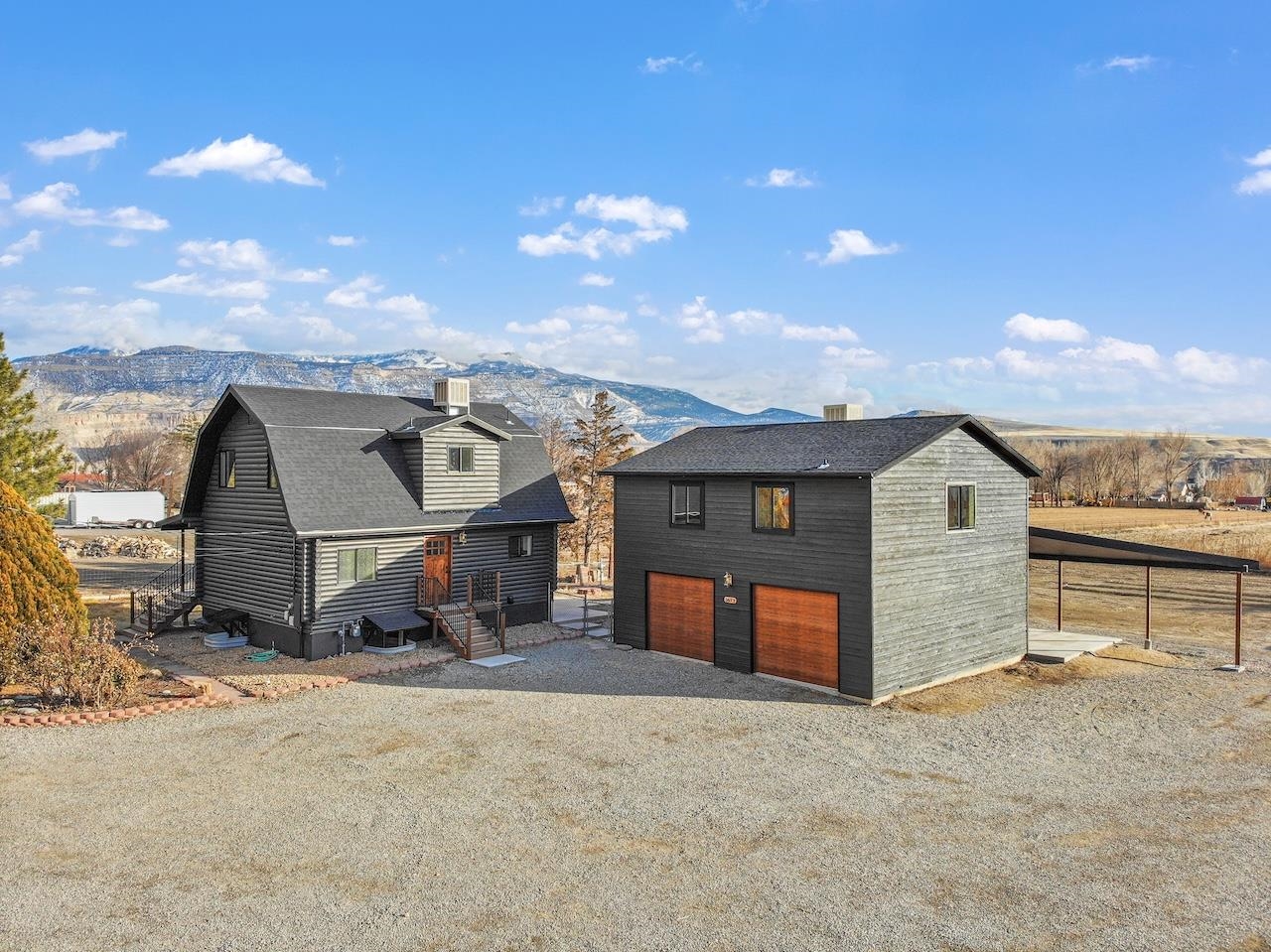 ADU! ADU! ADU! Are you looking for your Palisade Oasis??? Look no further! This beautifully remodeled log home will not disappoint! 360 views and town of Palisade just a bike ride away. Stained a charcoal on the oustside and whitewashed inside this modern true beauty is a must see! Solid wood exterior doors, new roof, drywall, paint, flooring, kitchens and marble in all all the bathrooms. And you read correctly, kitchens! This property also comes with a finished apartment above the large detached garage! 750 square feet of a spacious ADU. Apartment has full kitchen, 2 bedrooms, 1 bath, laundry and on its own utilities. Along with a living area and views galore! New septic installed for home and apartment. This home is out of the town limits and available to STR! Square footage and bedrooms include garage apartment (2088 SF Main Home and 750 Apartment)