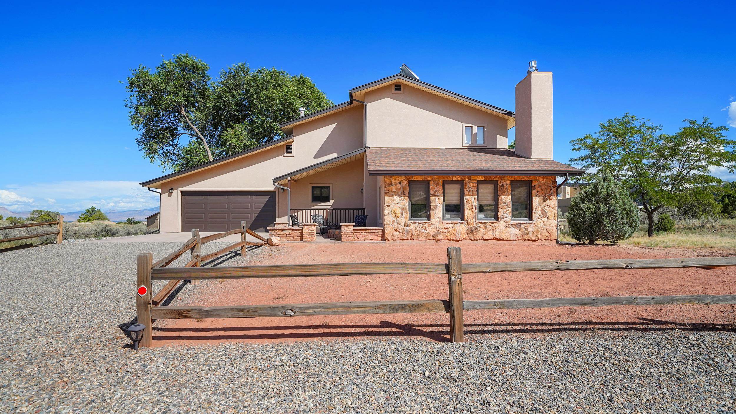 Nestled on over 2 acres in the heart of the high desert, this stunning two-story home offers 3,224 sq. ft. of thoughtfully designed living space with breathtaking views of the Colorado National Monument.  The property boasts a spacious deck perfect for soaking in the majestic landscapes and sunsets that define this unique location.  Mature trees surround the home, providing a serene oasis of privacy and natural beauty.  Inside, the home features a versatile floor plan, including a finished basement that adds both functionality and ample storage.  Enjoy sustainable living with an owned solar system, ensuring energy efficiency and lower utility costs.  Whether you're seeking a peaceful retreat or a place to entertain, this home provides an unparalleled combination of comfort, style, and natural beauty in one of Colorado's most picturesque settings.