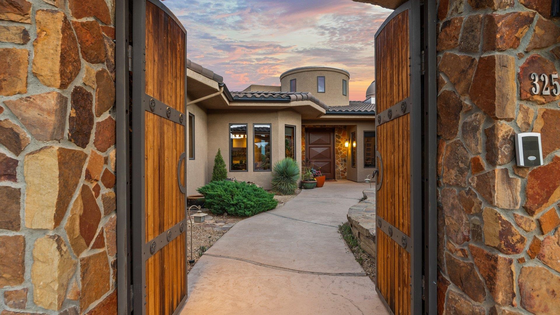 I am honored to introduce you to this magnificent Lopez Construction 2006 Parade Home. This premier residence overlooks the No. 1 Fairway of the prestigious Redlands Mesa Golf Course. This 4-bedroom-all En-suite, 6-bathroom, custom-built rancher with a full walkout was built with entertaining in mind. No expense spared-built by Chuck Lopez, arguably the preeminent builder of Grand Junction's finest homes. Windows all along the North and East walls of the kitchen and great room promise one immense, sweeping view of the Bookcliff Mountains and the Grand Mesa. At night, the lights of Grand Junction sparkle in the distance.  The views are further enhanced by a 12x20 ft. Panda Door, located in the great room, the sliding rail at the bottom of the Panda door barely interrupts the Noche Travertine that continues from the great room to the deck, where there's a Wolf gas grill, table, and chairs followed by a breathtaking view below of the putting green. This impressive home features 6105 sq ft of living space plus 1800 sq ft of heated garage and storage. This unrivaled beauty features a private gated courtyard, a theater room, a sauna, an elevator, and a private casita! For those astronomy enthusiasts, there is a built-in Observatory to be astonished or view the night sky! A full walk-out basement, 2 utility rooms, and a golf cart garage. A tumbled paver patio by Robinson Stone, fire pit, and limestone bench. The main level offers functionality with an open concept combined with luxury. Elevate your senses with the Custom Millwork throughout, High-end finishes, lighting, and hardware make this truly unprecedented!  Walnut and Alder Cabinetry, Solid Alder Doors, travertine, and walnut radiant flooring. Sub-Zero Appliances, Wolf Dual Ovens, and Gas Range. The exquisite primary retreat with postcard views is located on the main level. You can relax in the cast iron Japanese soaking tub atop Teak blocks. Cozy up with the two-way fireplace in the primary retreat. The quality of craftsmanship and attention to detail is an understatement. This beauty is specifically oriented to maximize sunlight and views (at various times throughout the day) Please see complete home features in associated docs. Enjoy our video! This stunning home deserves to be seen to be appreciated.  Schedule your private showing today!