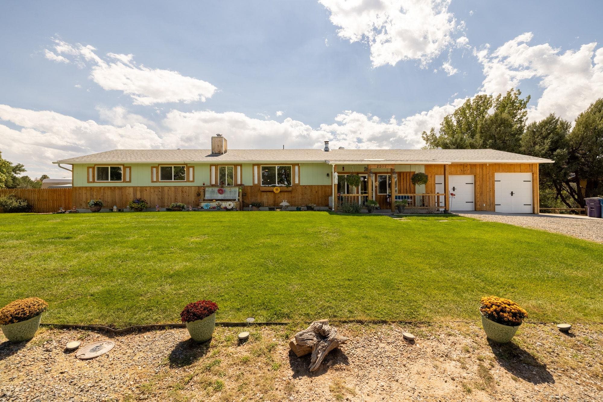 Welcome to your dream retreat in the heart of Redlands, where charm meets modern living. This lovingly updated home invites you to savor every moment, starting with the wraparound porch that frames stunning views of the Colorado National Monument—a perfect spot for your morning coffee or evening sunset.  Step inside, and you’ll be greeted by warm aspen tongue and groove walls, brand-new windows that flood the space with natural light, and beautiful hickory cabinetry paired with solid wood doors that add a touch of rustic elegance. Every corner of this home tells a story of thoughtful craftsmanship.  The magic continues outside, where your own private oasis awaits. Imagine cozy nights around the firepit, soaking in the 8-person hot tub under the stars, or hosting an outdoor movie night with your personal screen—staycations never looked so good.  With a clever floor plan that offers two distinct living spaces, this home provides endless possibilities. Whether you’re thinking of welcoming Furnished Finders, traveling nurses, or turning it into a sought-after Airbnb, this property is ready to meet your needs.  This home is more than just a place to live; it’s an experience, a lifestyle, and a must-see for anyone who appreciates the beauty of handcrafted design and the tranquility of nature.