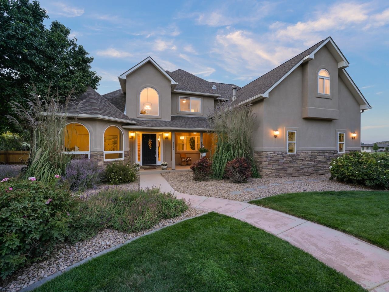 Welcome to the premier Redlands area of Grand Junction, CO! This exquisite estate located in the coveted Vista Del Canon subdivision, in the foothills of the Colorado National Monument, in a quiet tucked away cul-de-sac. Outdoor recreation surrounds this home, starting with the greenbelt trail behind the back yard and the open greenspace next door. There are tons of hiking & biking trails within minutes of the home. With absolutely stunning views of the Colorado National Monument just out the front door, professionally landscaped front & back yards, and a 4-season bloom plant cycle, there is beauty all around. Head inside to experience the LIGHT all around you, as well as the gorgeous renovation completed in 2021. Central A/C, tall ceilings, wide-plank hardwood floors (harvested regionally), contemporary fixtures & a new CHEF'S KITCHEN. Just off the entry is an office/library/den with beautiful french doors. Flow through the dining space with coffered ceiling into the main living area's soaring yet intimate space. The custom tile fireplace & mantle and hand-crafted balustrades set an inviting, natural tone connecting the upper and lower levels. Pause for the kitchen :: your eyes will want to take in the contemporary custom-milled melamine cabinets, sleek quartz countertops, Thermador 6-burner gas range & dishwasher, extra wall oven & wine refrigerator. Then take in the LIGHT & VIEWS at the breakfast nook area. The eat-in counter seats 4 (the bar stools are included). The laundry/utility room off the kitchen has ample storage/space, new tile flooring & perfect organizers (including a laundry chute from upstairs). The generous primary bedroom on the main level features private access to the back patio & a fantastic en-suite spa bath. The en-suite includes a large jetted tub, walk-in steam shower, dual vanity & two walk-in closets. Find the 3 additional bedrooms upstairs all with their own walk-ins, a shared 4-piece, and full bath. The supersized bonus/play/rec room is perfect for any type of purpose to fit your lifestyle. Live your best indoor/outdoor life in the private backyard with stunning Trex deck, pergola & immaculate landscaping. The 3-car garage provides loads of vehicle space, potential for a working area & includes the Tesla car charger. Additional space for RV parking is available next to the garage & the dog run area is hard-wired for a hot tub. Come see it to believe it!