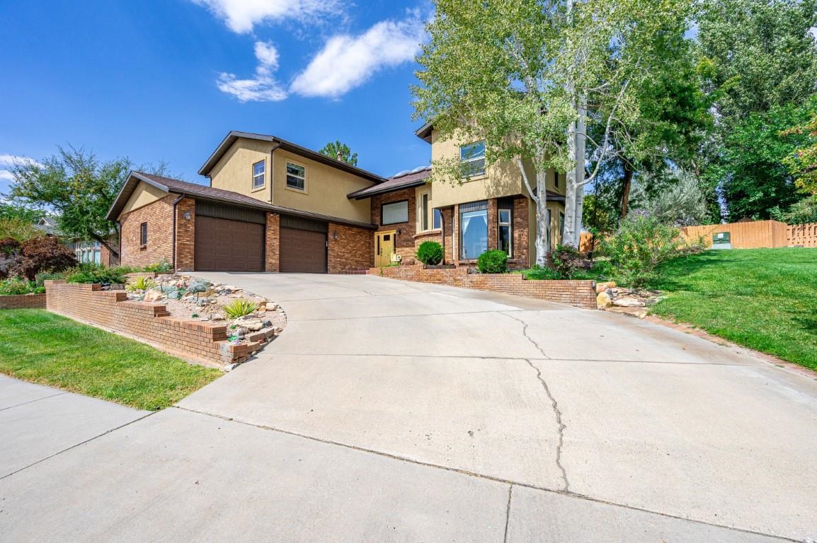 Back on the market at no fault of the home. Welcome to this exceptional luxury home in the coveted Crest View subdivision of North Grand Junction. Overlooking the subdivision's private lake, this two-story residence offers stunning views and serene green spaces. The home features a striking stucco and brick exterior and countless custom upgrades. Inside, the spacious living room boasts vaulted ceilings and a cozy gas fireplace. The kitchen, a true centerpiece, includes custom cabinetry, granite countertops, under-cabinet lighting, and an instant hot water system, all paired with a dining area offering picturesque lake views. The main level includes a bedroom (currently a home office with a wet bar and in-floor heating), a spa-like bathroom with a steam shower, a functional laundry room, and an oversized two-car garage with quiet belt-driven doors. Step outside to a covered patio and backyard oasis, complete with a hot tub and seating area. Upstairs, the split floor plan includes two bedrooms, a shared bath, and an impressive master suite with in-floor heating, luxurious fixtures, a jetted tub, a walk-in shower, and dual closets. Schedule your showing today to experience this incredible home!