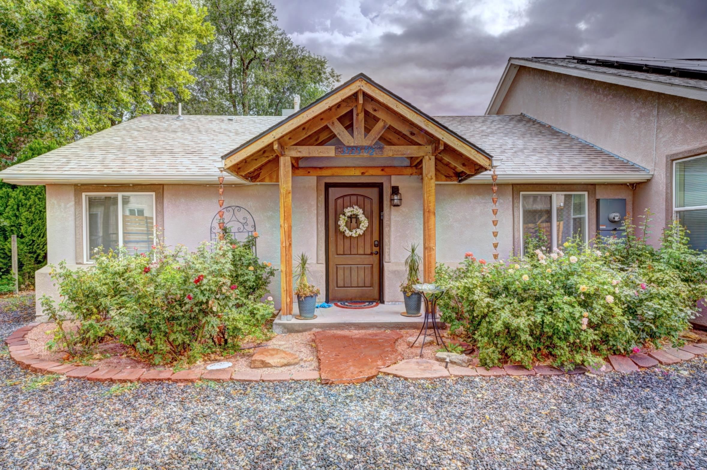 Tucked away between neighboring vineyards, is one of Palisade's best kept secrets. This remarkable home has been meticulously remodeled with amazing additions that make it better than brand new, including newly installed solar panels. The bright and airy floor plan showcases four bedrooms, vaulted ceilings and appealing design ideal for entertaining. On the main level, you’ll find two well-appointed bedrooms connected by an adjoining bathroom and unique loft spaces. The heart of the home is the open kitchen and living area, designed with style and functionality in mind. The kitchen showcases elegant cabinetry, an induction cooktop, a double oven, and generous space at both the eat-in dining area and island bar. Adjacent to the kitchen and living room is the Primary Suite and ensuite. This room is truly beautiful and the ensuite is built for relaxation, featuring a walk in shower with dual-showerheads and a jetted soaking tub.  The expansive walk in closet with custom built-ins ensure ample storage and organization. Down the hall from the Primary Suite is a guest bathroom with a striking copper shower that further enhances the upgrades and over all appeal. This next part of the home is the entertainment hub, with a crafted bar and original materials from the original outbuildings and 1920's homestead, it truly makes you wonder if you are still in your home, or stepping in a tavern.  Upstairs is an added bonus room that is the perfect home theater room and guest bedroom, with views of the Grand Mesa, it could also make a great home office. Just outside the bar, is your comfortable outdoor entertaining area, complete with a fire pit, pergola and mature yard. Parking will not be an issue with an oversized two car garage, and a 0.27 acre lot. This also has potential for conversion to a separate additional dwelling unit (ADU). Located just a short stroll from the Riverbend Park and Palisade High School, this property presents an exceptional opportunity for those seeking the charm of Palisade living.