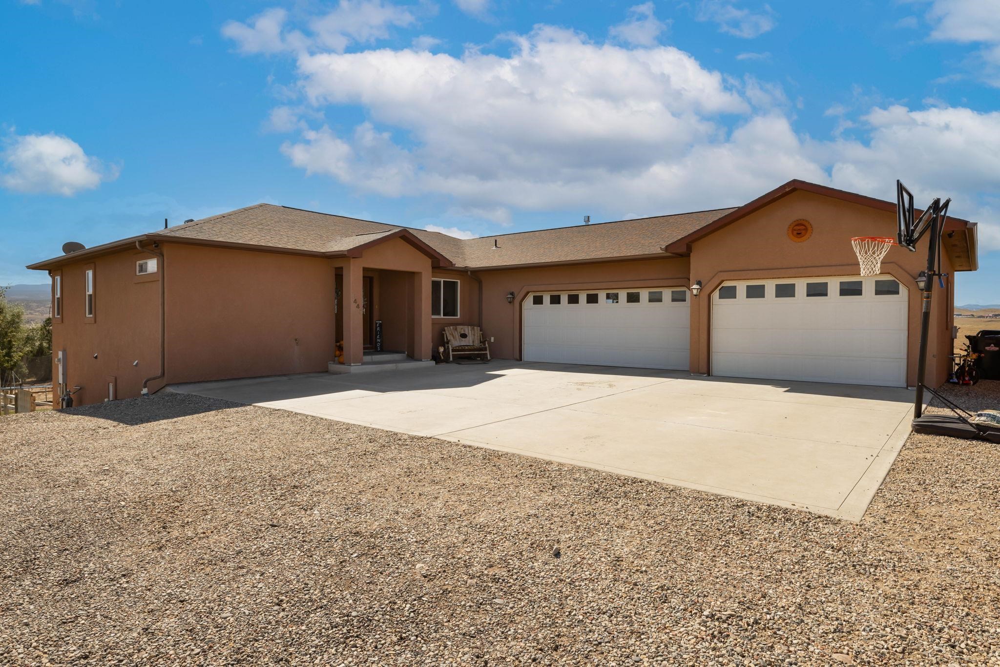 VIEWS VIEWS AND MORE VIEWS! With views of Grand Mesa, San Juans, Uncompahgre. This home has over 2 acres, 4 bedrooms with an office or a 5th nonconforming bedroom. The open concept formal living with gas fireplace and kitchen welcomes you as you walk through the front door. The main level primary bedroom has a walk-in closet and 5-piece bathroom. Downstairs features a walk out basement with 3 bedrooms and an office or 4th bedroom, 1 full bathroom and a family room. There is also a 30ft x 40 ft, 12 ft walls shop, for all of your toys, equipment, whatever you want!