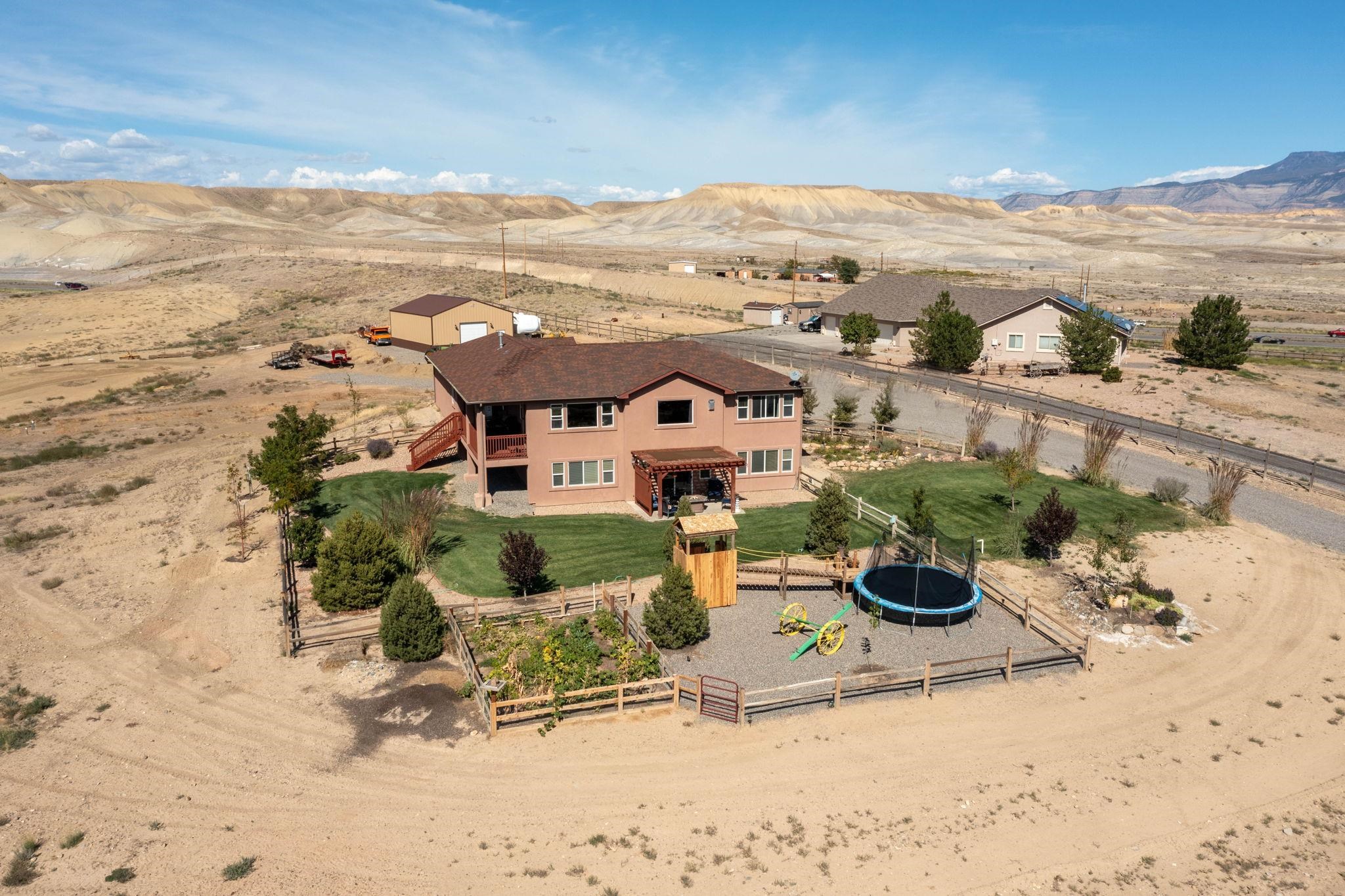 VIEWS VIEWS AND MORE VIEWS! With views of Grand Mesa, San Juans, Uncompahgre. This home has over 2 acres, 1 share of irrigation provided via HOA, 4 bedrooms with an office or a 5th nonconforming bedroom. The open concept formal living with gas fireplace and kitchen welcomes you as you walk through the front door. The main level primary bedroom has a walk-in closet and 5-piece bathroom. Downstairs features a walk out basement with 3 bedrooms and an office or 4th bedroom, 1 full bathroom and a family room. There is also a 30 ft x 40 ft, 12 ft walls shop, for all of your toys, equipment, whatever you want!