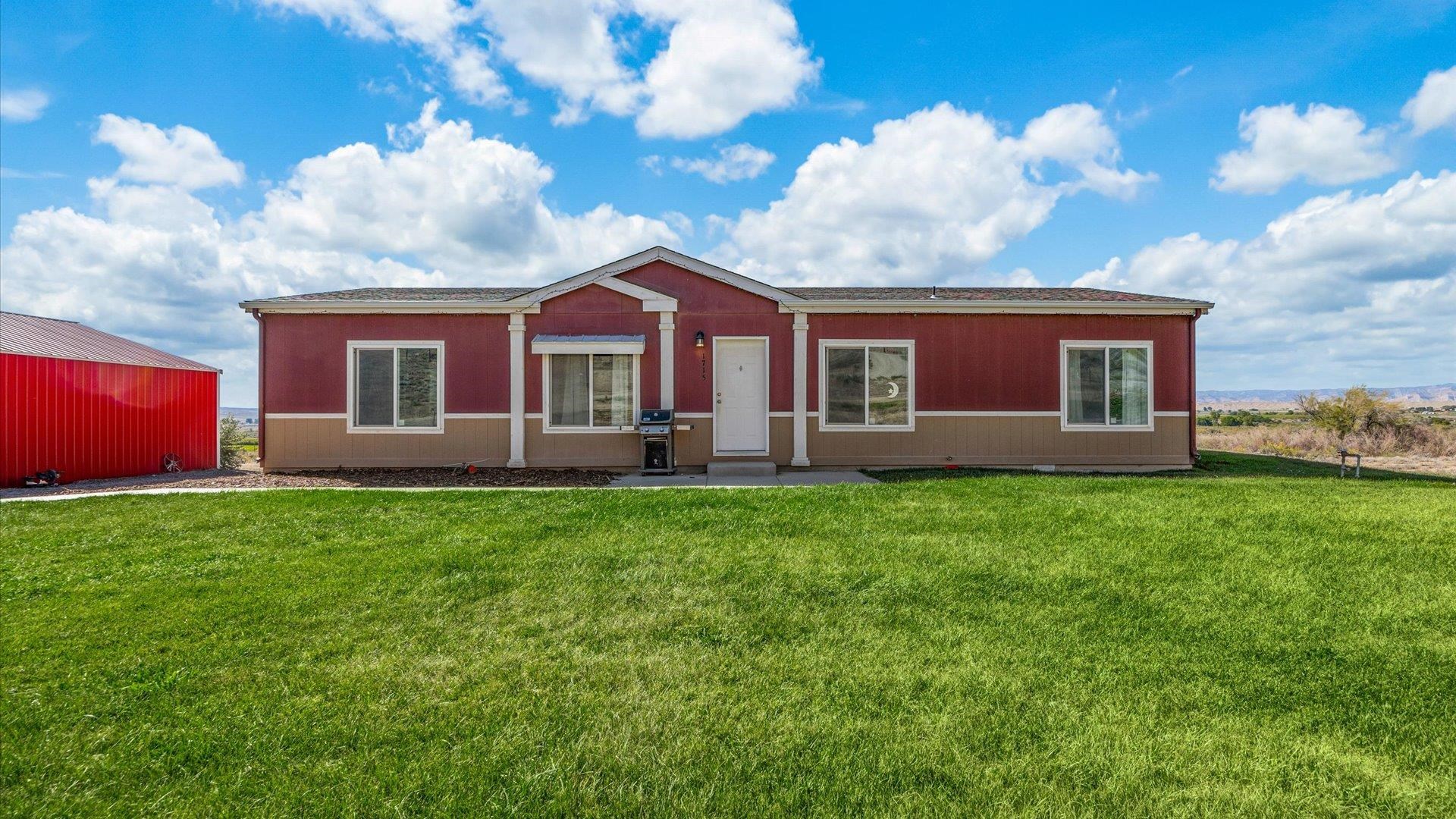 Discover your countryside haven on 10.97 acres in peaceful Mack, Colorado! This 2020 manufactured home offers 1,456 square feet of modern living with a well-designed split floor plan, featuring 3 bedrooms and 2 bathrooms. With a beautiful primary suite with a spacious 5 piece primary bath, second bathroom complete with an air tub. Modern finishes throughout, along with central air, an a smart water heater ensure comfort year-round. Step outside to find an RV hookup, a large 30x30 shop for all your projects, a relaxing hot tub, an above-ground swimming pool, and a trampoline. There's also a pond for drainage water and beautifully landscaped front and side yards, perfect for enjoying the outdoors. A new wider, paved driveway is being installed by dominant easement holder. This property offers the potential for subdivision into multiple parcels. Seller is now offering a $2,000 carpet allowance. If you’re looking for space, privacy, and rural charm, this property has it all!  Don't miss your chance—come see it before it's gone!