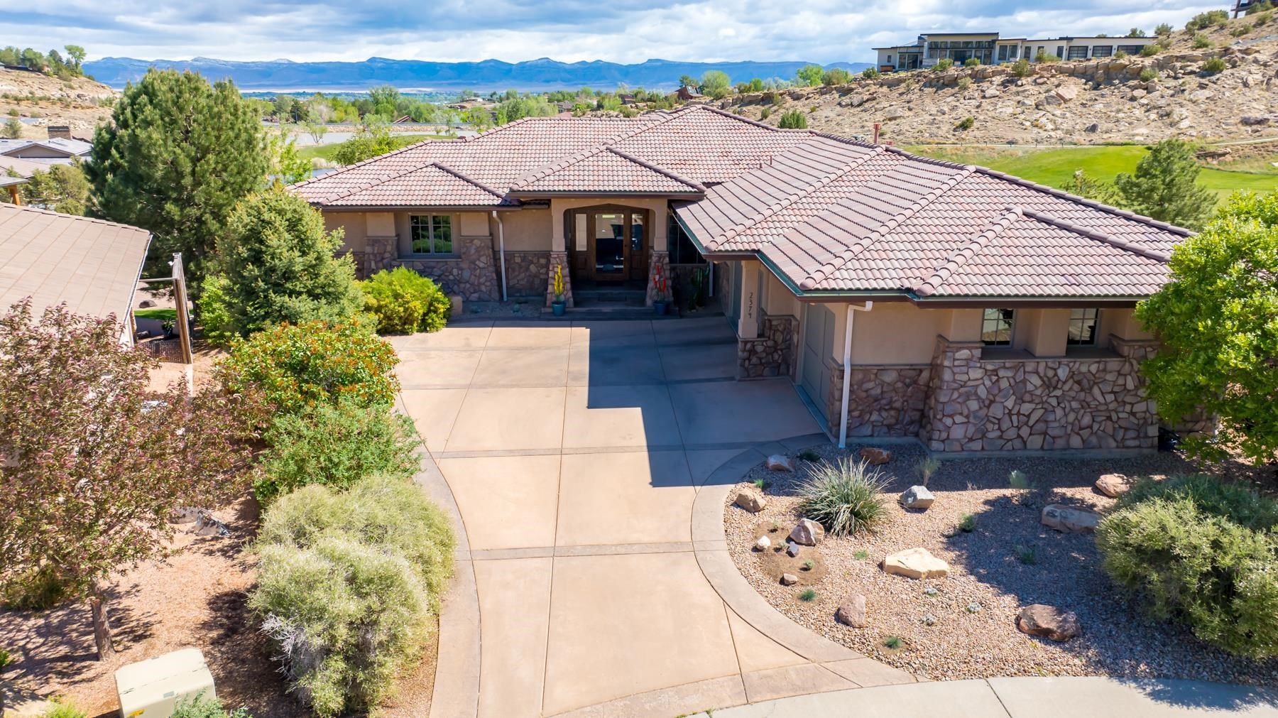 Beautiful custom Ranch style home with lower level. 4198 sq ft 5 bedroom + office on large lot in Shadow Lake area of Redlands Mesa. Beautiful layout with huge great room and gourmet kitchen built for entertainment. Incredible master suite on main level.  Amazing views from the family room. The massive glass front door opens to 16 ft ceilings adorn with wood beam details and a wall of glass with a double sided fireplace. Private office off the entry with built ins and storage, if you want to work from home. The master suite opens onto the upper deck and master bath and walk-in are nothing short of spectacular and needs to be seen to be appreciated. The basement has 3 bedrooms, exercise room, 2 bathrooms, wet bar area, and family/game room area! This entire home has been gone through and is ready for you to just move in and put your feet up...until you decide to hike, bike, play golf, go out to eat...you name it!! Book a private showing today, much more to see!! Discover the Beauty!