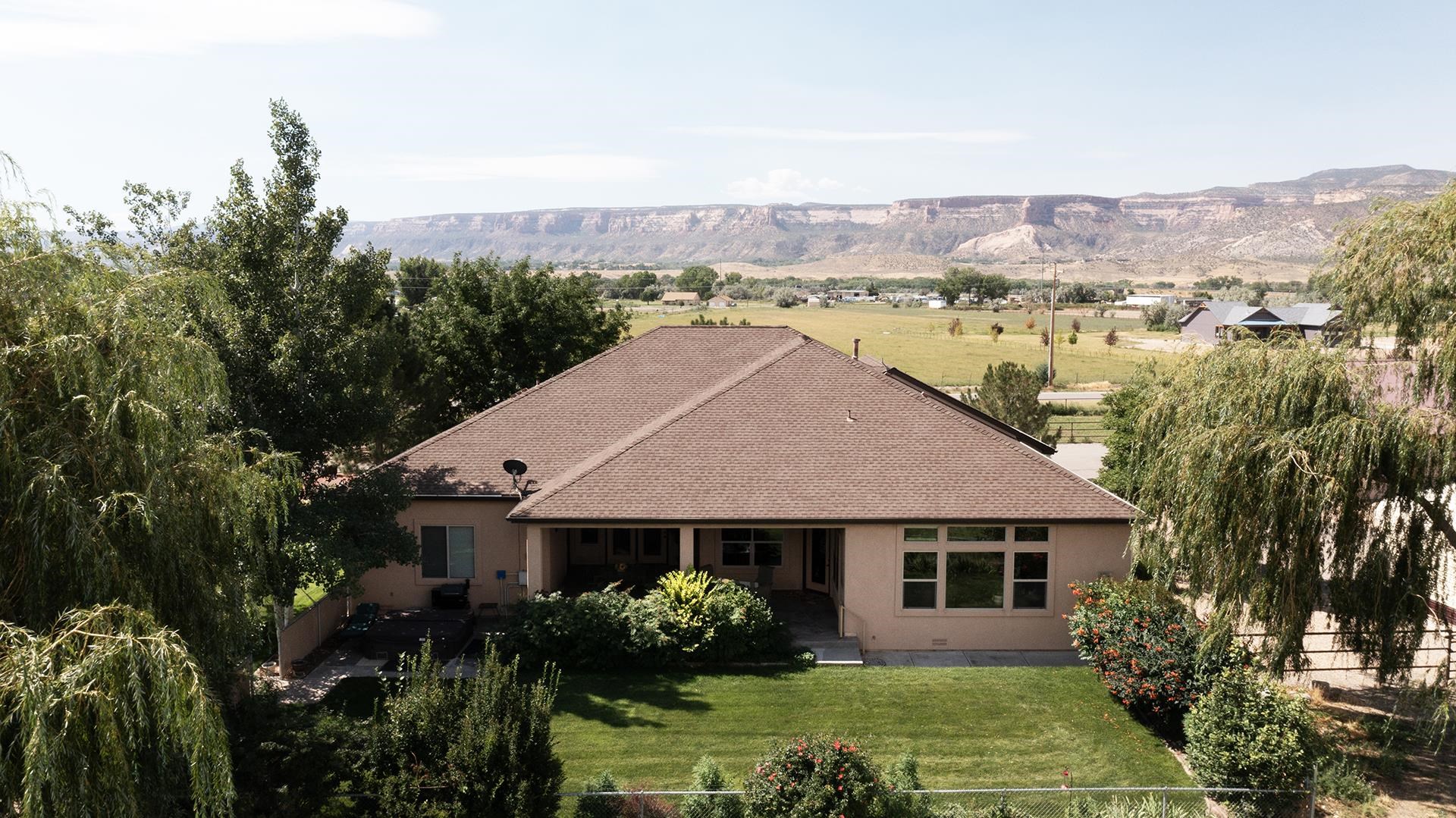 Everything you’ve hoped for and more! Situated on 8.85 acres with 10 shares of GVIC this custom built 4-bedroom, 3-bathroom, 2733 square foot rancher is beautiful inside and out. Equipment shed for RV storage and height is adequate for a stack wagon to drop hay. 3 cuttings of grass per year plus option to graze the 4th cutting. Inside is filled with lots of natural light from the large windows that also offer great views in every direction. A big open kitchen offers granite countertops, an island and custom-built knotty alder cabinetry. Master suite is inclusive of a 5-piece bath with a jetted soaker tub. From the back patio you can enjoy the unobstructed views of the beautiful and mature landscaping as well as the irrigated pastures that have been well maintained.  Plenty of room to entertain and host with an additional 1100 square foot, 2-bedroom casita on property. Bring your horses, RV’s, OHV’s or 4H animals and enjoy the elbow room and views!