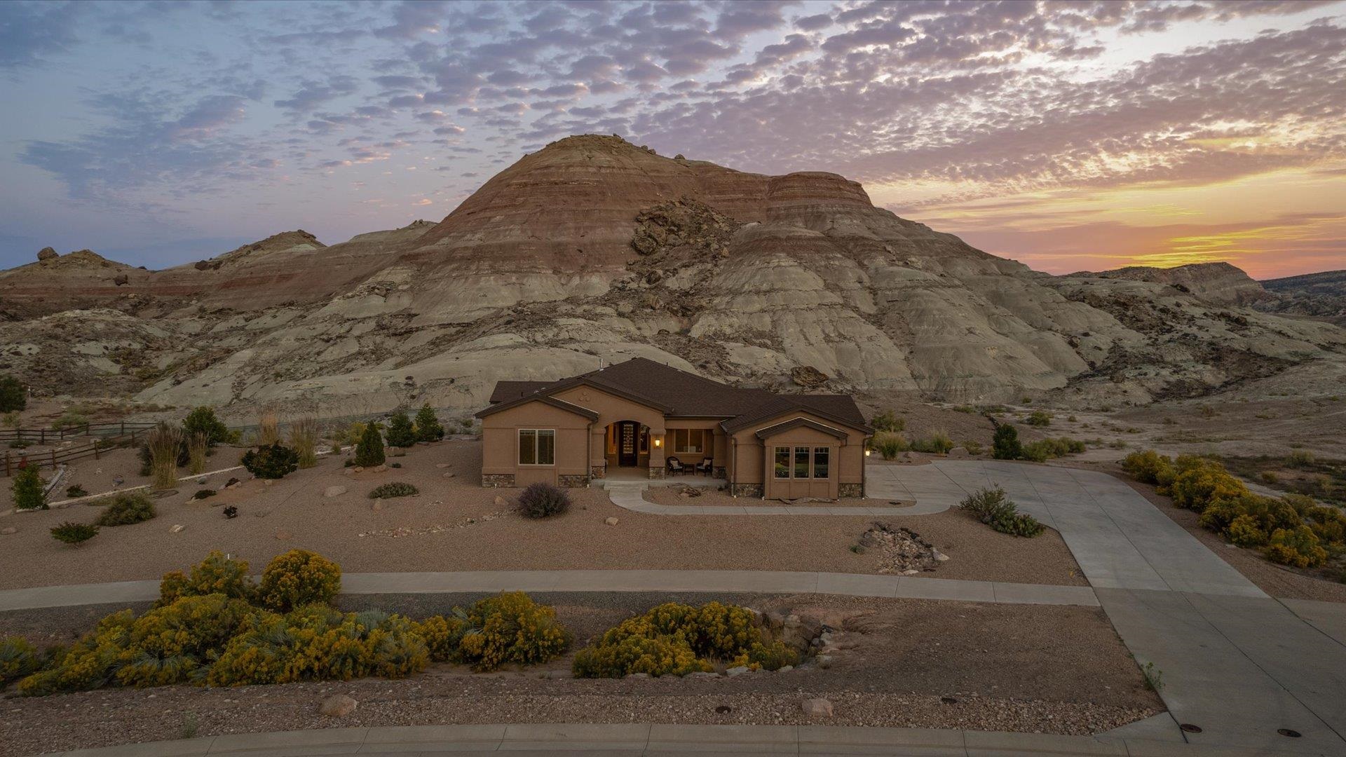 Discover the best of Colorado living at 2283 Trail Ridge Road! This stunning one-level home is perfectly situated to offer breathtaking views of the Colorado National Monument, while providing easy access to all the outdoor adventures Grand Junction has to offer, including hiking, biking, and nearby parks.  Step inside to find an open floor plan, designed for seamless living and entertaining. The home features beautiful finishes throughout, creating an inviting and modern atmosphere. From the spacious living room to the stylish kitchen, every detail has been thoughtfully crafted to elevate your living experience.  Outside, you'll enjoy a private backyard paradise with a cozy fire pit, perfect for relaxing under the stars. The low-maintenance landscaping ensures you can spend more time enjoying the serene surroundings rather than maintaining them.  This property combines natural beauty, comfort, and modern amenities—your perfect Grand Junction retreat.