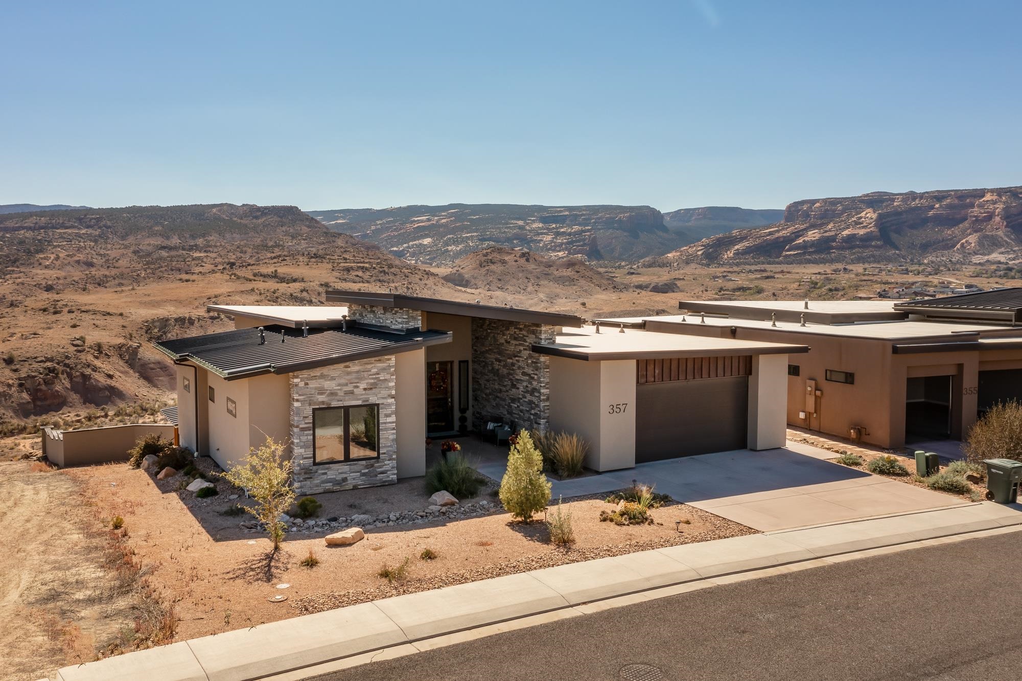 Welcome to this stunning modern home in Redlands Mesa. 360-degree views of the Colorado National Monument and the Grand Mesa. Custom built home by Nate Porter was built with every detail designed to make this smart home ideal for entertaining. Smart home control operates blinds, security cameras, lighting, ceiling fans, tv and sound systems. Open concept gourmet kitchen, large dining area and beautiful living room have floor to ceiling windows to take in the jaw dropping views. Main floor also features master suite, guest bedroom with en suite bathroom, office (non-conforming bedroom) and half bathroom. Walk out lower-level features beautiful wet bar, another half bathroom and a large family room. Exterior is fully fenced and landscaped. Golf cart garage is attached to the side of the home. Enjoy the views from the upper deck OR take in the expansive views from the hot tub on lower-level deck. This is one you will not want to miss!!