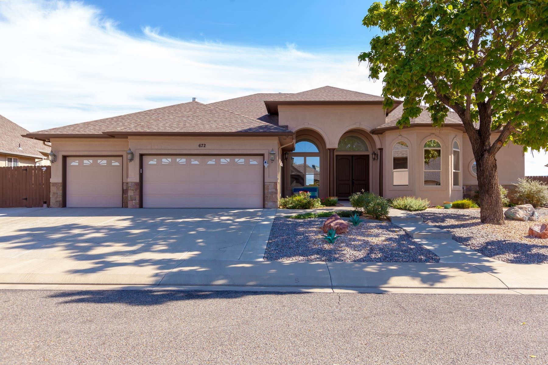 Stunning home with great curb appeal, enter through mahogany double doors into a foyer opening into a living room, dining room with 3 sided fire place, office & 1/2 bath. The primary bedroom features new sliding glass doors, double walk in closets,  5 piece master bath. The kitchen is great for entertaining opening onto the family room with views of the Grand Mesa. Newer LG Refrigerator with glass door, wine cooler, gas range and plenty of storage. The Cherrywood cabinets with granite countertops and a breakfast bar to seat many.  The split bedroom floorplan offers a newly remodeled bath with Kohler shower install. The backyard features a fabulous covered outdoor kitchen granite countertops, warming table, gas grill & refrigerator. The covered patio with retractable awnings for privacy. All while having outstanding views, xeriscape yard & hot tub