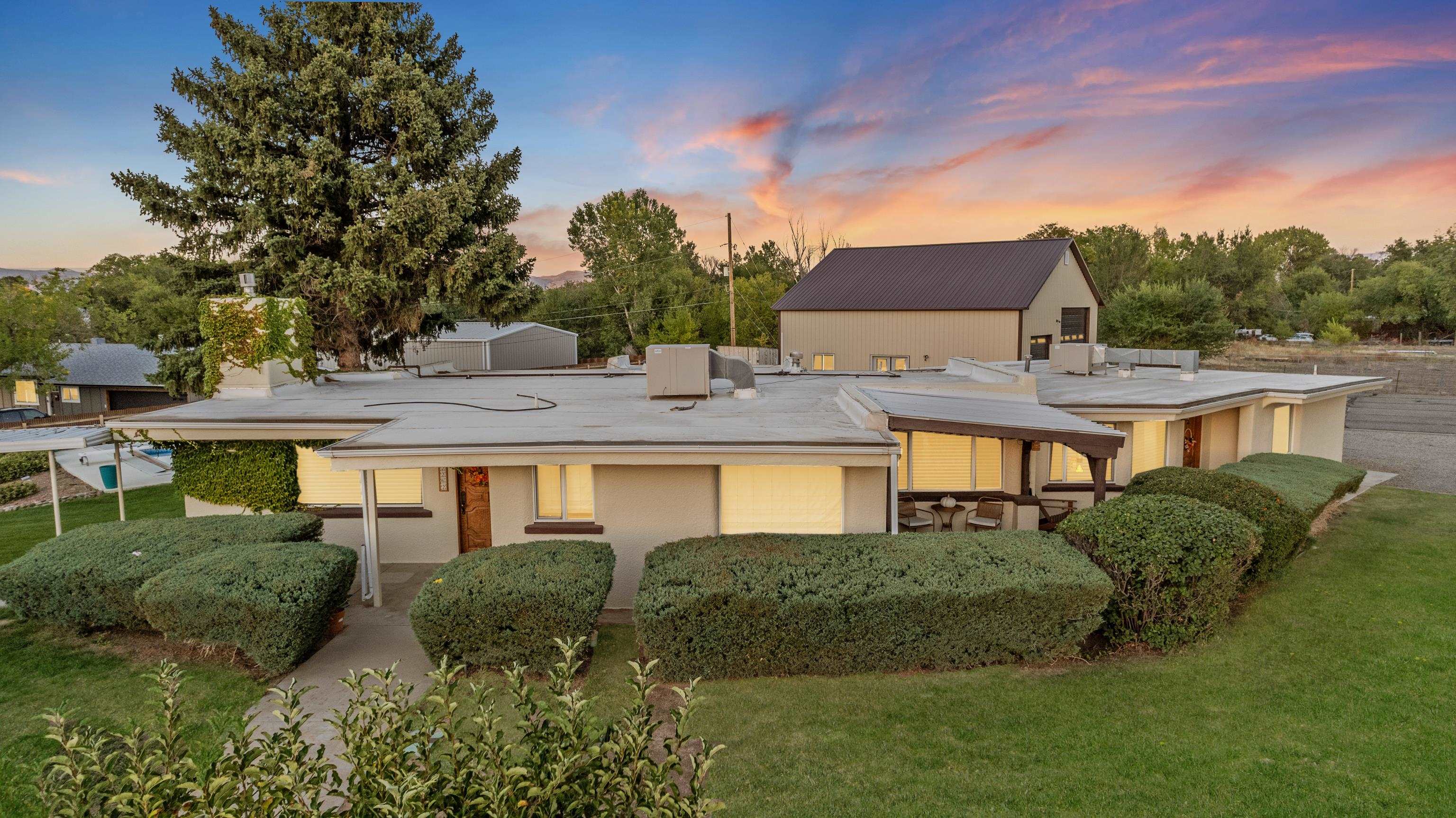 For the first time in over 30 years, this enchanting 1948 mid-century modern adobe home is available, offering a rare opportunity to own a piece of Redlands history. Nestled on 2.57 picturesque acres in the highly sought-after Redlands area of Grand Junction, this 3-bedroom, 2-bath home exudes warmth and Old West charm.  The property features an inviting in-ground saltwater pool, perfect for enjoying Colorado's sunny days, and a 40x40 detached shop that provides ample space for projects, hobbies, or storage. With its blend of classic design and rustic character, this home offers the perfect retreat for those looking for serenity and space, just minutes from local amenities. Additional value in development potential with R4 zoning!   Don’t miss out on this once-in-a-generation chance to own this unique home in a prime Redlands location!