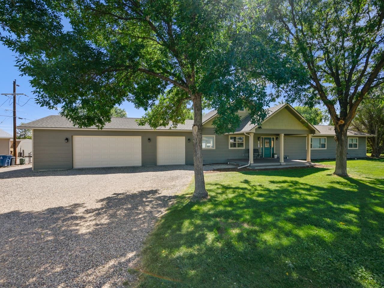 Would you like a home with lots of room to roam? Well it awaits on 1.13 acres, in the highly desirable Redlands area. Tucked away, this home is a quiet & serene retreat. An ideal horse & animal property, there is lots of space for trotting & wandering. Out front is a well kept yard with landscaping, a covered porch, & room for an RV. Walk on inside to find an immaculate, open, & incredibly well lit living space. The dining room has plenty of space for a large table & other accessories or furniture, & will certainly have you ready to invite/entertain guests. The kitchen is just around the corner & contains all the essential stainless steel appliances, stylish cement finished countertops with complimentary backsplash, & some beautiful glass paned cupboards to complete the aesthetic. You'll find the sit up counter is the perfect spot for a casual meal, & the big pantry has lots of room for all your goodies, & doubles as a laundry space. The living room itself has large transom windows which bring forth the sunshine & a double door to the back patio. The electric pellet stove in the corner brings a cozy & warm feel to the room both decoratively & functionally. Something else to note & love about these large spaces are the contemporary fixtures & the gorgeous hardwood flooring to provide that extra touch. The primary suite has lots of room to unwind & relax, & access to a walk-in closet. The primary en-suite has a large tub/shower, slate style tile, heated floors & an awesome wood style vanity. Off the dining room you’ll find two large additional bedrooms with lots of closet space as well as a  four piece bathroom with some really cool retro style tile work. Downstairs is a finished basement complete with utility space, an additional bedroom &  another full bathroom. The recently added three car garage has ample storage space & some built in ceiling shelving to help illustrate that point. The home also comes with a surprise bonus attic room rife with possibilities & options. The backyard is one of the crowning jewels of this property. A large open patio, a side yard, the shed, & of course space for horses, chickens or other pack animals are just some of the many things to love about the outdoor space. Additionally there is a hot water hose bib/spigot. The property comes fully irrigated & there is no pesky HOA. There is also the option for solar with panels installed. If you’d like to see your ideal home with room for animals, this one is waiting for you!