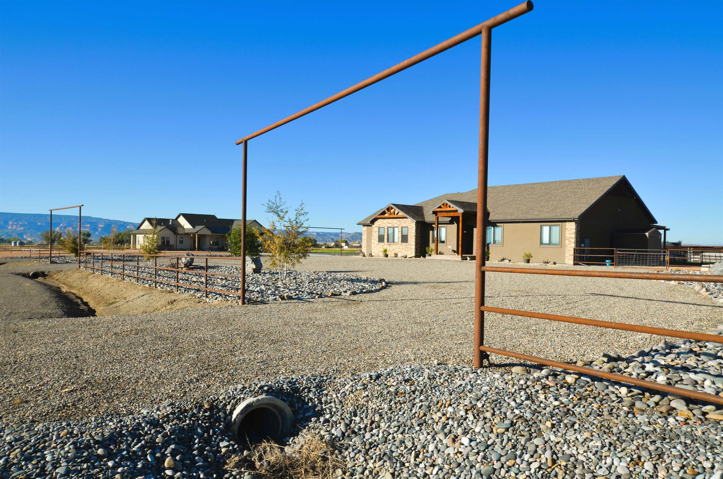 Ranch style home on 1.58 acres. Views! Room for Animals, Round Pen, Shop, Pool, Toys, RVs, Trailers, and more. Zoned ATF. 5 bedrooms, 4 bathrooms, and an oversized 3 car garage. Open concept living area with split floor plan design. Kitchen offers a breakfast bar, walk-in pantry, and gas stove. The Laundry Room, 1/2 Bathroom, Garage, Office/small 5th bedroom, and Primary Bedroom are on the South side of home. The large primary bedroom has a huge 4-piece en suite, walk-in closet with built-ins, Bluetooth speaker, toilet room, double sink vanity, and walk-in shower with 2 shower heads. There are 3 more bedrooms (one with 3/4 en suite), large storage closet, and full bathroom with linen closet on the North side. Oversized Garage with 220, Utility Sink, and dedicated outlets for Refrigerators and Freezers. Tankless Hot Water Heater, granite throughout, and lots of storage! Outside offers circular drive, corner lot, tons of RV parking, 50 amp and 30 amp plugs, raised garden area with shed, lean-to animal shelter with pens and 200 amp service in place for future shop or barn, frost-free freshwater hose bib, and horseshoe pits. Huge back patio with pergola, firepit, 220 for Hot Tub, gas line for BBQ, and Surround Sound!