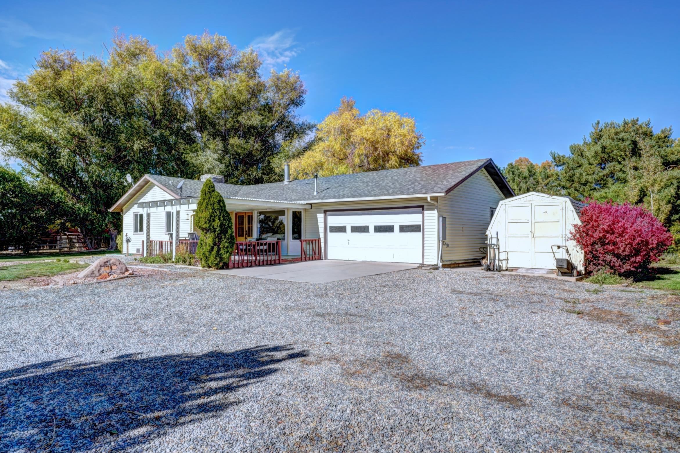 This property truly exemplifies luxury living, featuring a stunning kitchen including a giant island with marble countertops that would delight any chef. The irrigated acreage offers a unique opportunity for those looking to cultivate their own hobby farm—hello goat yoga! Or enjoy fresh fruits from your very own orchard filled with apricots, plums, and peaches!  Nestled away on a quiet drive, this home provides a serene retreat where you can unwind and enjoy breathtaking summer sunsets. The luxury vinyl plank flooring throughout the space adds a modern touch, complemented by new windows and sliding doors that invite natural light and enhance the home’s appeal.  Additionally, the potential to add an Accessory Dwelling Unit (ADU) opens up exciting possibilities for guests, rental income, or multi-generational living. Overall, this property is a rare gem that perfectly balances luxury, tranquility, and the charm of rural living.  So much potential for a lovely life here!