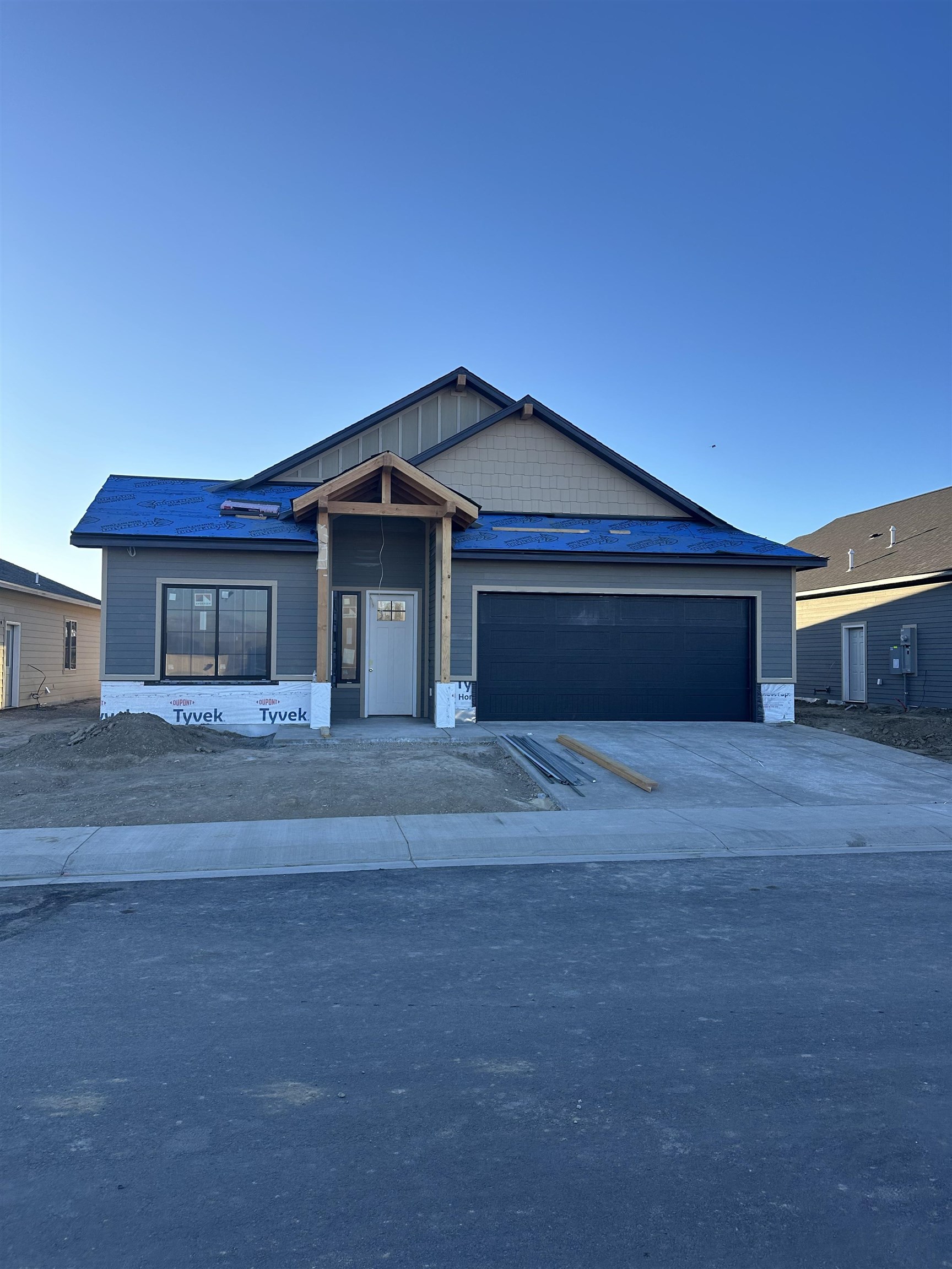 Discover the newest premier subdivision in Northwest Grand Junction, where award-winning Builder, TreyTyn Homes, presents a beautifully designed and highly functional ranch-style home with quality finishes throughout. As you enter, a grand covered entryway leads into an inviting foyer, with a conveniently situated fourth bedroom or office tucked near the front for easy access and privacy. The heart of the home opens into a stunning living, dining, and kitchen area, crowned with cathedral ceilings and highlighted by an electric fireplace, enhancing both ambiance and grandeur. The open-concept layout seamlessly unites these spaces, making it perfect for entertaining and family gatherings. The chef-quality kitchen boasts a large island for meal prep and casual dining, premium cabinetry, quartz countertops, and a full stainless steel appliance package, including an elevated gas range and refrigerator. The primary suite, located on the opposite end for optimal privacy, features tray ceilings for added architectural appeal, an en-suite bath with dual vanities atop quartz-topped cabinetry, a walk-in shower with custom tile accents, a private lavatory room, and an oversized walk-in closet. Two additional bedrooms are thoughtfully placed nearby, along with a full guest bathroom that mirrors the home’s luxurious finishes, complete with a tub/shower combo with tile surround. Outside, the expansive backyard features an oversized concrete covered patio, ideal for enjoying Grand Valley’s beautiful scenery and climate. The property includes 10 feet of RV parking on the north side, while the builder will install full perimeter tan vinyl fencing and front xeriscape landscaping, adding both curb appeal and value!