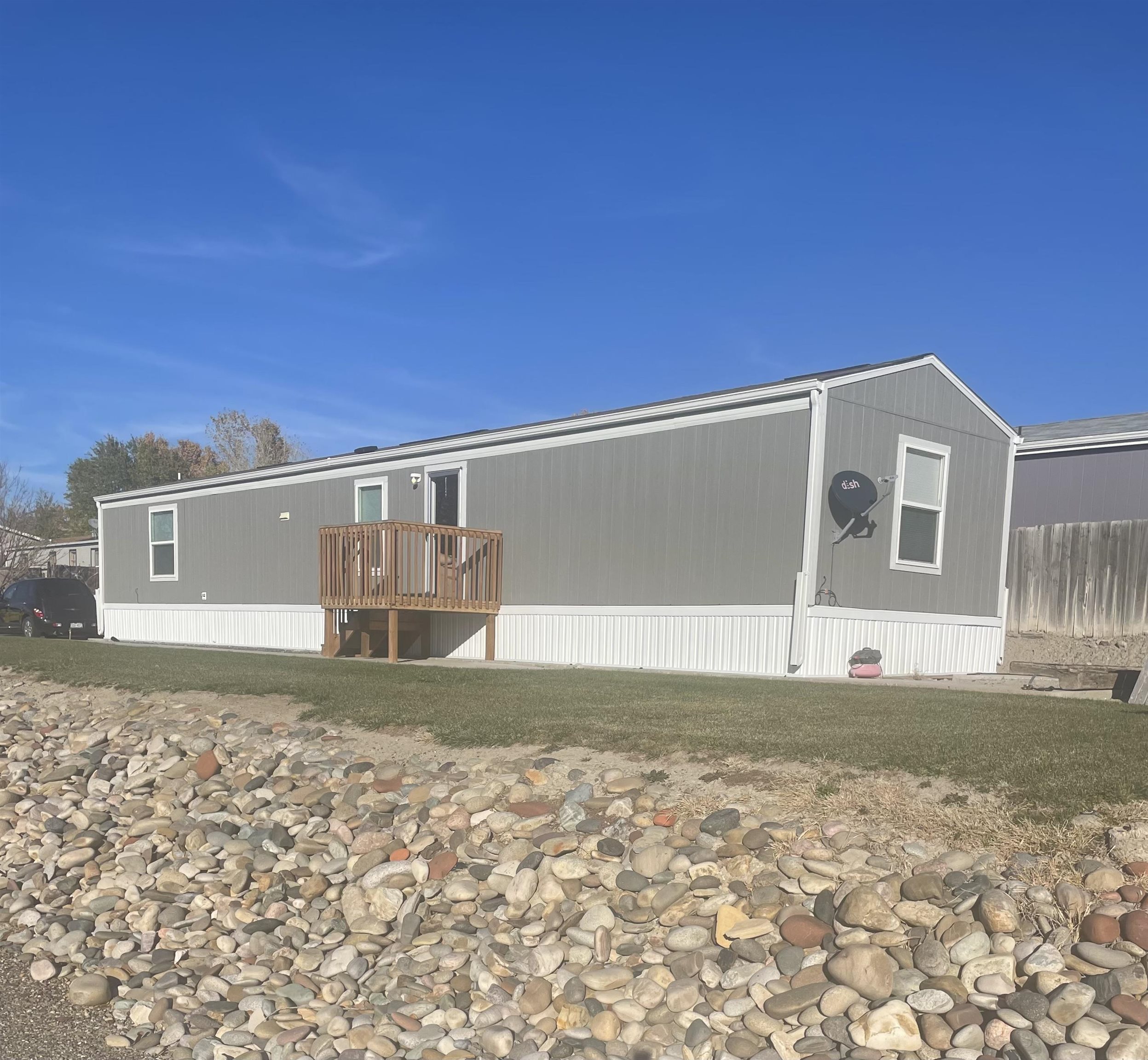 Discover country charm and modern convenience with this beautiful manufactured home on its own lot in the highly desirable Country Living Mobile Home Park! Featuring a spacious, open layout, this home is designed for comfort and functionality. The inviting living area flows seamlessly into the kitchen, creating an ideal space for entertaining or relaxing with loved ones. Durable and stylish plank flooring throughout the home makes maintenance a breeze while adding a touch of elegance. Equipped with quality cabinetry, ample storage, laminate counters, and upgraded stainless steel appliances (all included!). Three generously sized bedrooms with ample closet space and two full bathrooms complete the home’s comfortable layout. Laundry area Tucked away near the kitchen for easy access and efficiency. Enjoy stunning Grand Valley views from the spacious, fully landscaped lot, complete with irrigation water access through the HOA. Experience peace and quiet in a serene country setting, all while being just minutes from Fruita and Grand Junction, where you'll find shopping, dining, and entertainment. Don’t miss out on this perfect blend of tranquility and accessibility!