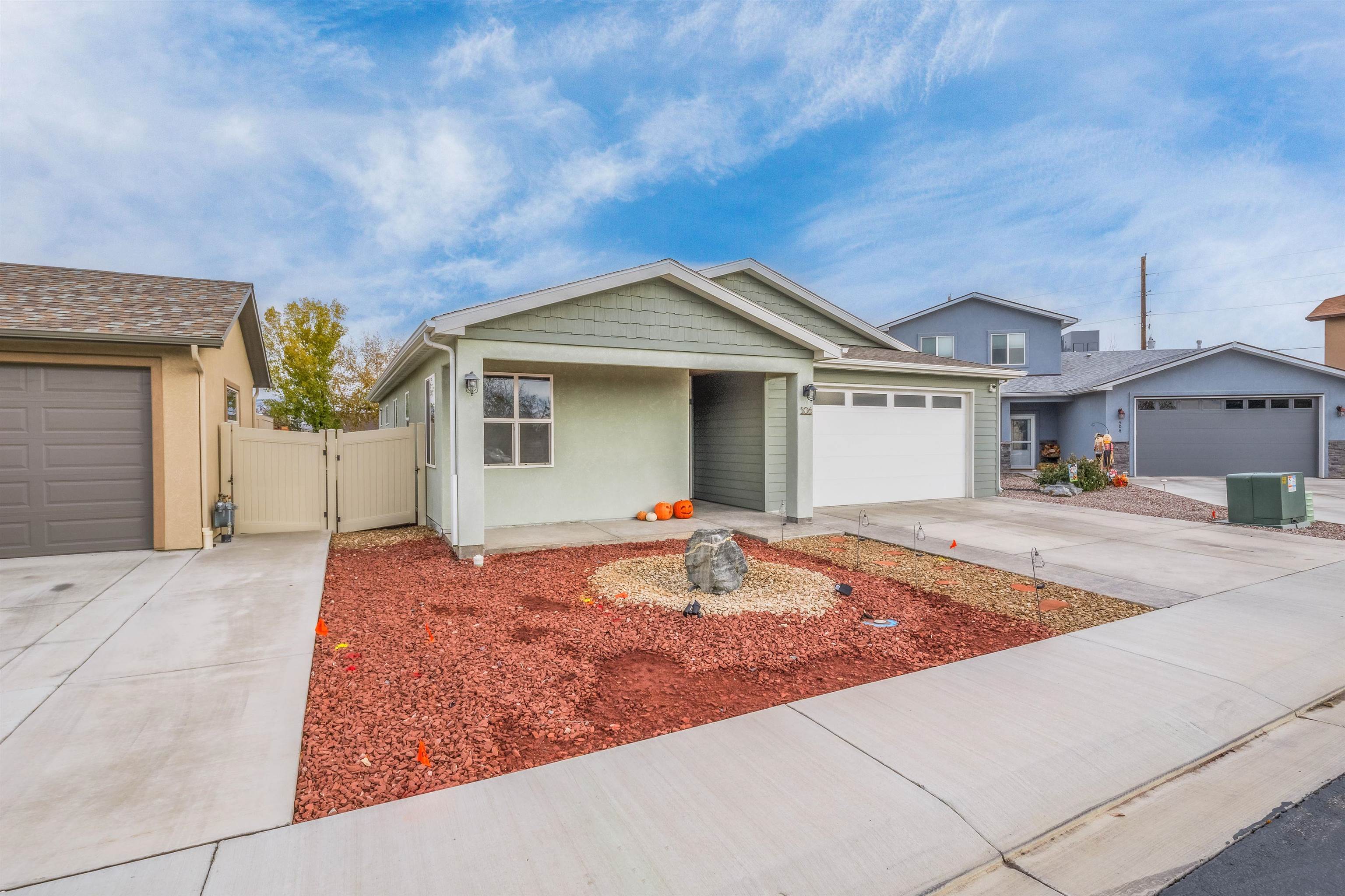 Nestled in a peaceful cul-de-sac, this charming low-maintenance rancher features elegant finishes and an open, inviting layout. The split-bedroom design ensures privacy, with a spacious primary suite that includes a luxurious walk-in shower and a generous walk-in closet. Rich wood-grain laminate flooring flows throughout, harmonizing beautifully with the custom cabinetry and glass tile backsplash in the kitchen. The oversized granite island provides the perfect space for gathering and entertaining, while clerestory windows throughout flood the home with natural light. Offering lock-and-leave convenience, the home boasts a beautifully xeriscape front yard with a small grassy area off the private back patio.