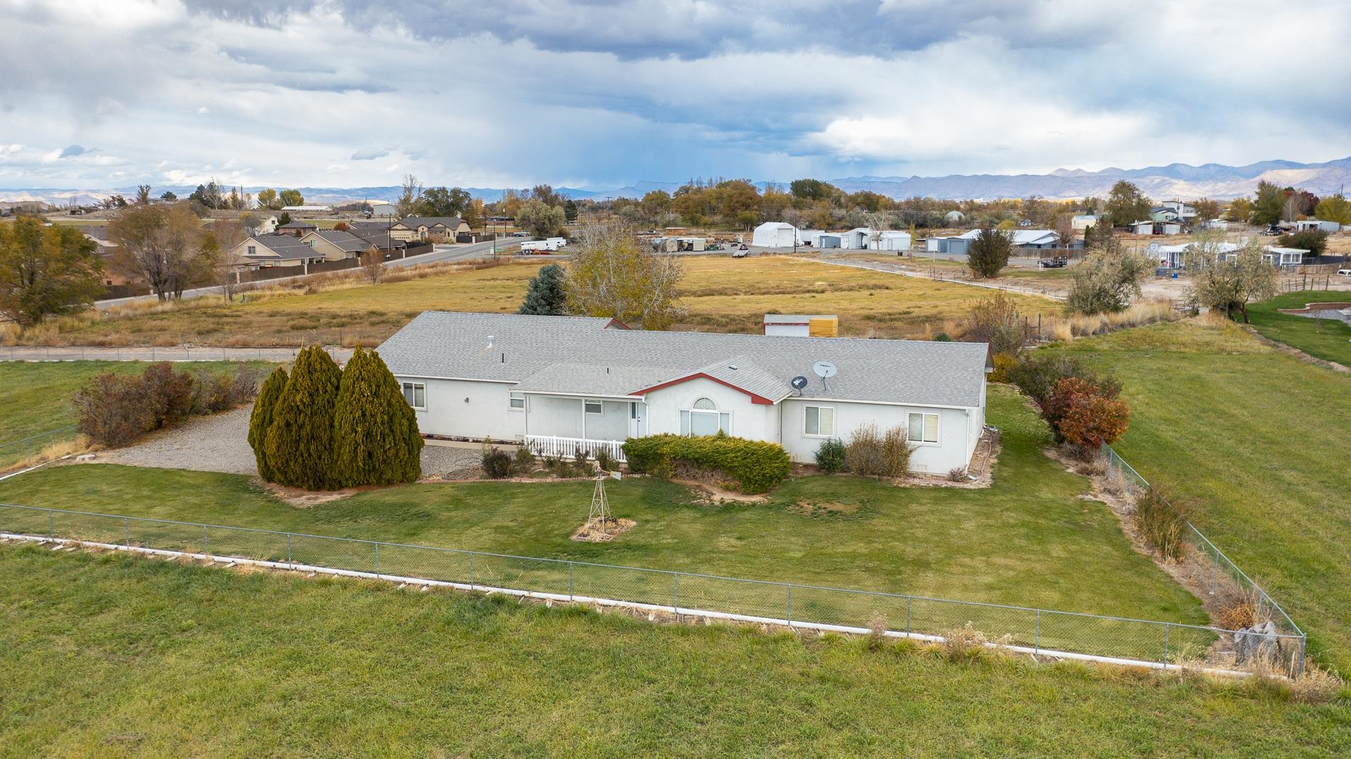 Whether you are looking for a hobby farm, a home with extra elbow room, or for a potential development project, this Fruita property could be a great fit! Situated on 3.2 irrigated acres, this ranch-style home offers 3-bedrooms, 3-bathrooms, and a large garage with a 9-ft door and workshop. Price includes 4 shares of GVIC water stock. Property is located within the city limits and is zoned community residential. Buyer to verify the possibility of subdividing the land with the City of Fruita.