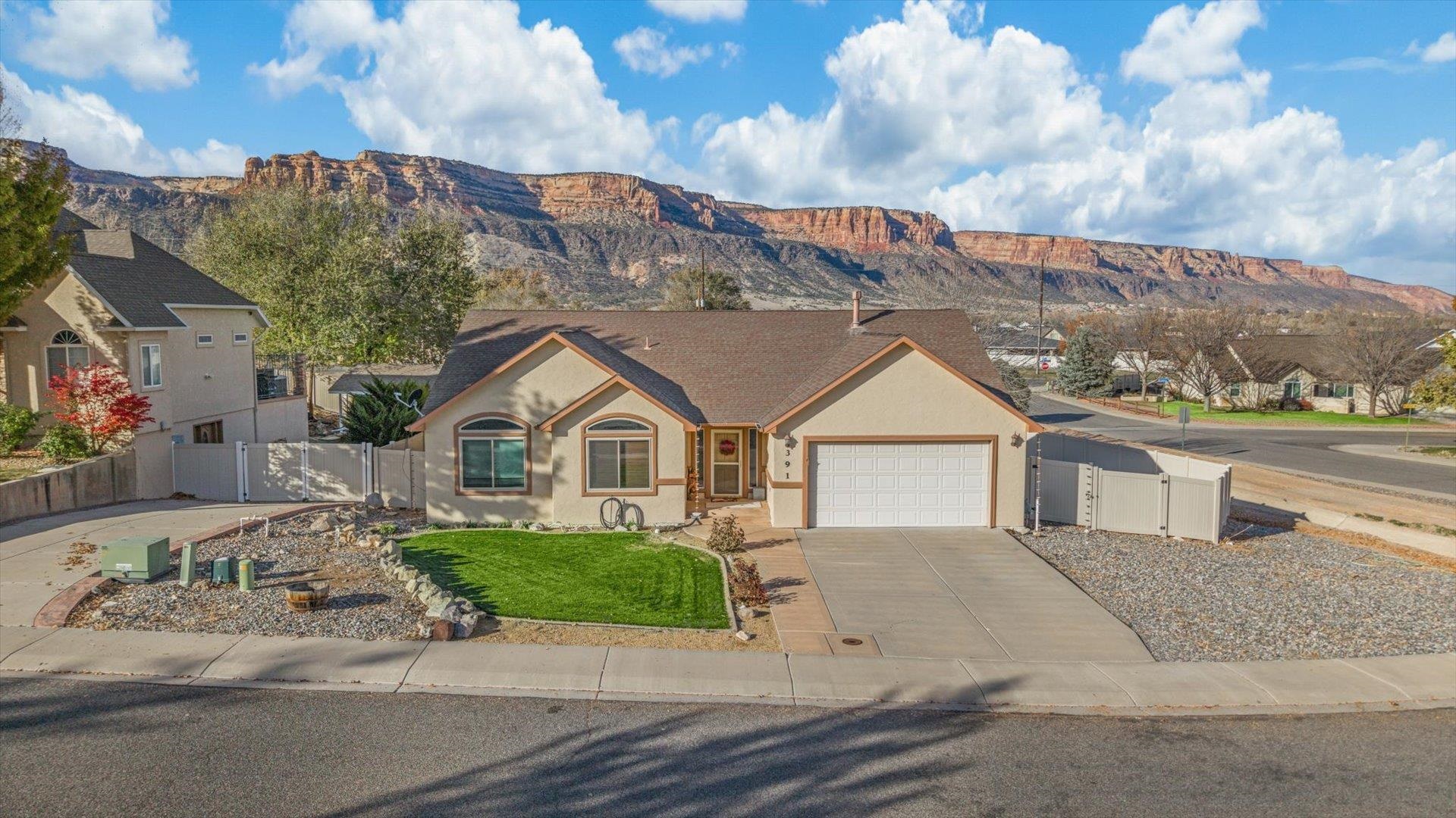 Great ranch-style home in the Redlands with spectacular views of the National Monument. As you walk in, you’ll notice the large entryway, vaulted ceilings, abundant natural light, and open floor plan. The spacious kitchen features newer appliances, barstool seating at the island, and a cozy corner breakfast nook. The backyard offers privacy, unobstructed views, and multiple entertaining spaces on the patio, including two pergolas (one newly added), and the hot tub is included. The landscaping in the front and backyard has been beautifully maintained, creating a serene outdoor oasis. Additional updates include new exterior paint, new windows throughout the home, and a brand-new water heater.  The property is enclosed by a vinyl fence, offering both style and security. The oversized 2-car garage also has additional storage space in the back. This property provides low-maintenance living with modern updates and plenty of charm.