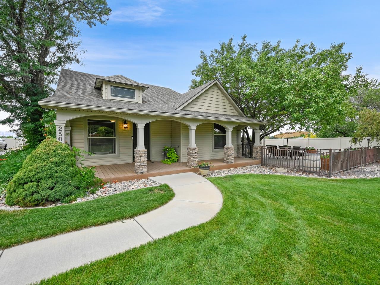 A piece of history in the heart of Grand Junction, Colorado! This home, originally constructed in 1900, has undergone an artful transformation. Through thoughtful renovation & expansion, the result is a residence that exudes character & charm while embracing updated conveniences. Approach via a front patio, & recently fenced front yard. The detached 3-car garage provides ample storage. Step inside to discover a spacious living area that combines historic details with contemporary design. A gas fireplace in the living space creates an inviting focal point & a generous dining area sets the stage for memorable gatherings. The gourmet kitchen, with a large island providing functionality & style, & stainless steel appliances, including a gas stove, ready to cater to your culinary aspirations. The quartz & granite countertops complement the richness of the hardwood floors that grace the entirety of the living space. A pantry, repurposed from the original front door, serves as a charming reminder of its heritage. The breakfast nook invites you to savor morning moments bathed in natural light. Adjacent to the dining area find an office space and a guest room complete with an attached 3/4 bath, ensuring visitors' comfort & privacy. On the opposite side of the office is a second living space with the original fireplace, access to the storage cellar, panoramic picture windows, & a door that opens onto the front patio. Moving forward, another guest room, accompanied by an attached full bath, awaits. Retreat to the rear of the home to the primary suite, a sanctuary with abundant natural light, dual walk-in closets, & a lavish five-piece bath. A manicured lawn & well-appointed landscaping create a welcoming facade. Revel in the views of the Bookcliffs & surrounding valley from your covered front deck or the fenced patio. With a fireplace, shade trees, garden beds & additional covered deck, this space is perfect for outdoor gatherings. With its proximity to schools, St. Mary's Hospital, CMU, shopping, dining, parks, & historic neighborhoods, this opportunity to reside in such an exceptional home is a rarity. Experience the harmonious blend of history and modernity – a home that stands as a testament to the heritage of Grand Junction, inviting you to create your own story within its walls.