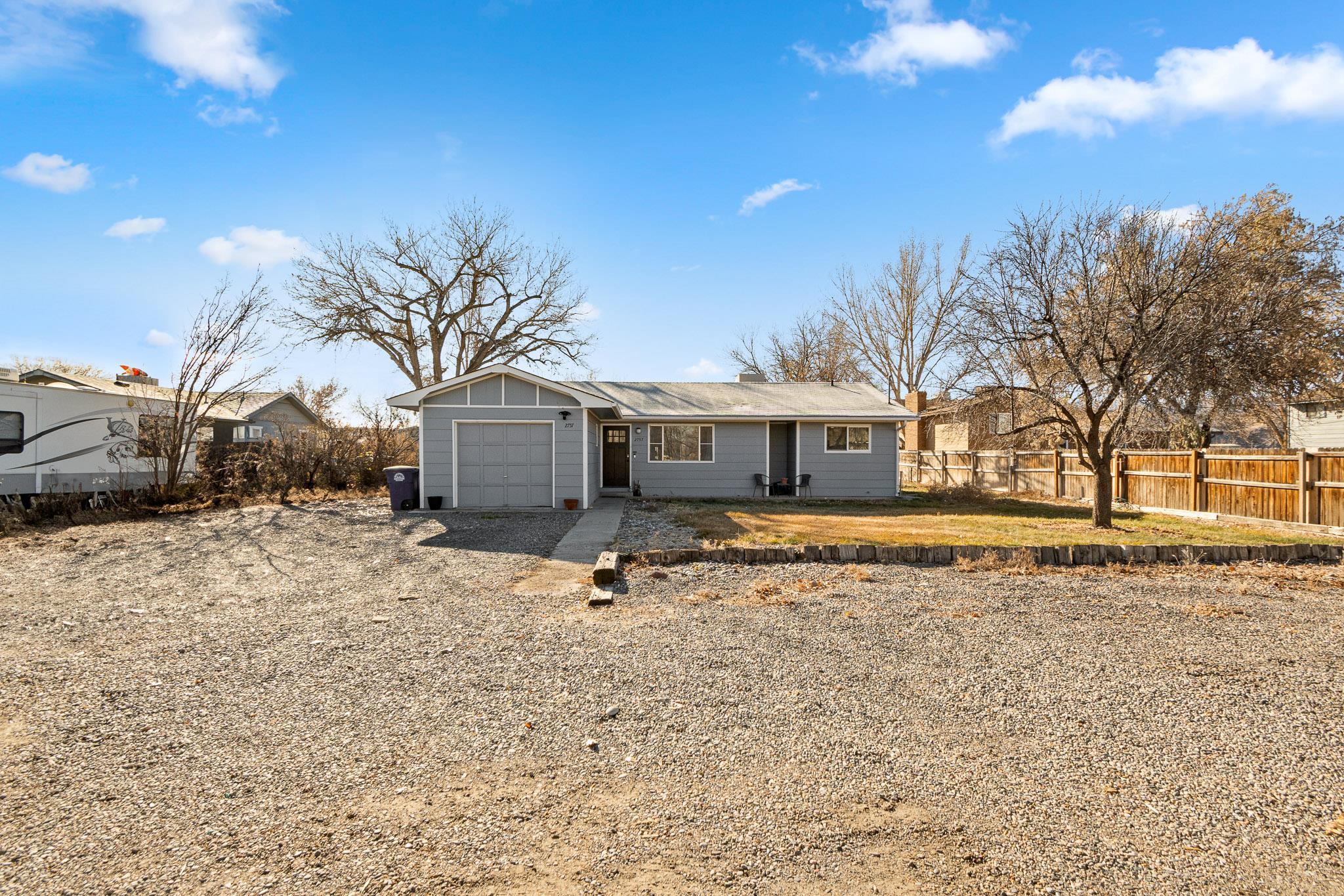 Charming country style home near the city with RV parking and hookups. Enjoy the best of both worlds with this delightful 3-bedroom, 2-bathroomm 1-car garage home that offers a peaceful country vibe just minutes from city conveniences. Backing to open land, this property provides stunning views and a sense of privacy that's hard to find. The spacious living area features a warm and inviting feeling. The home offers a sought after split floorplan and an addition 240sq ft sunroom that's not included on the total square footage.