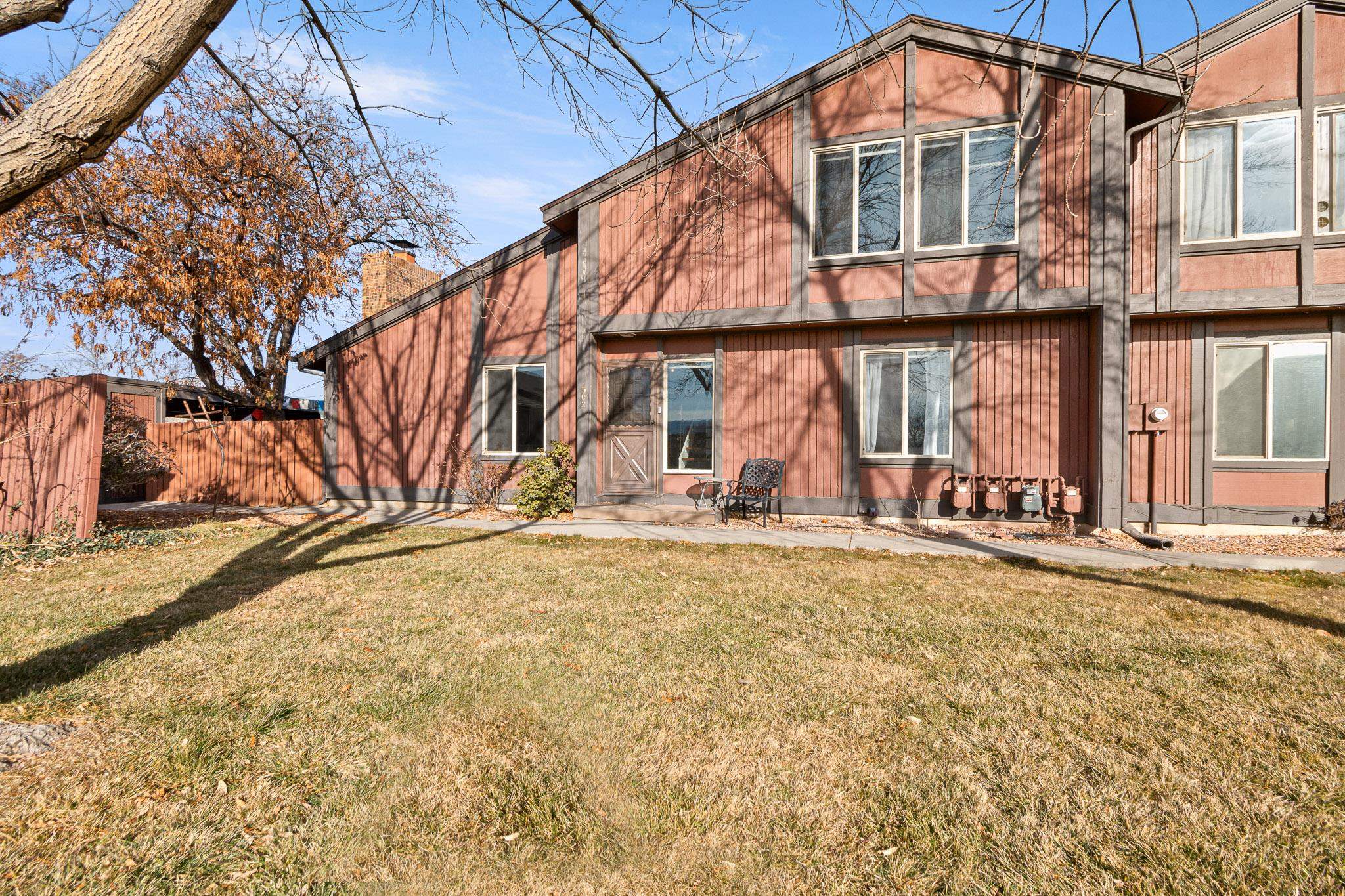 Welcome to this delightful southwest-facing condo, perfectly situated in the heart of North Grand Junction. With 2 bedrooms and 2 bathrooms, this spacious and thoughtfully designed unit offers the perfect blend of comfort, convenience, and tranquility. Enjoy the benefits of its southwest orientation, which provides ample natural light and warm winter sun, while mature deciduous trees offer cooling shade in the summer-creating an inviting retreat year-round. The open concept floor plan features high ceilings, a modern kitchen, and large windows that bathe the space in natural light. The kitchen is conveniently located near the rear entrance, with easy access to private patio, carport parking and charging station. Step outside your front door to a beautifully maintained green space, offering a peaceful and private outdoor area with no neighboring condos in sight. This condo is a rare gem in a prime location-don't miss your chance to see it. Schedule your tour today!