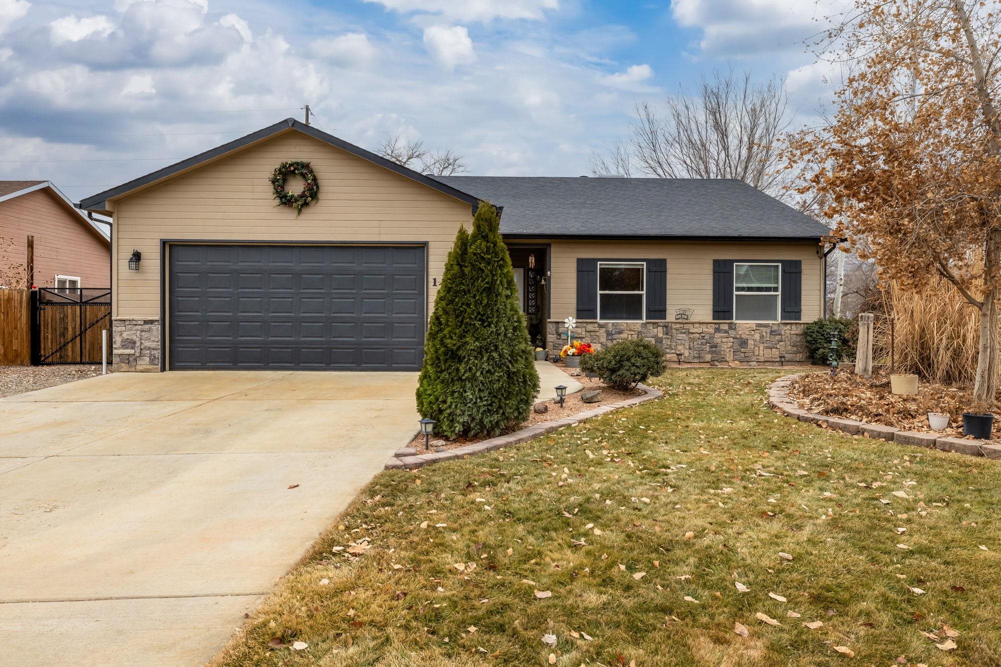 Looking for the perfect blend of space, style, and location—all for under $500,000? Welcome to 1280 Tara Dr., a fantastic corner lot with only one next-door neighbor, just a short walk to downtown Fruita and the Fruita Community Center! This stunning 4-bedroom + office, 2-bathroom home features 1,732 SqFt of beautifully designed living space. The open-concept floor plan boasts vaulted ceilings and hardwood floors, creating a warm and inviting atmosphere. The kitchen shines with a peninsula offering barstool seating, perfect for casual dining or entertaining, while the cozy gas-log, stone fireplace adds charm to the living area. Step outside and discover an outdoor oasis in the xeriscaped backyard, complete with an enclosed covered patio, a pond with water features, garden boxes, a fire pit area for gatherings, a shed for extra storage, and even RV parking. Located near the Big Salt Wash Trail and the Riverfront Trail. Nestled in the peaceful Evening Breeze subdivision, this home is the perfect retreat within the amazing Fruita community! Schedule your tour today and see why this incredible property is calling you home!