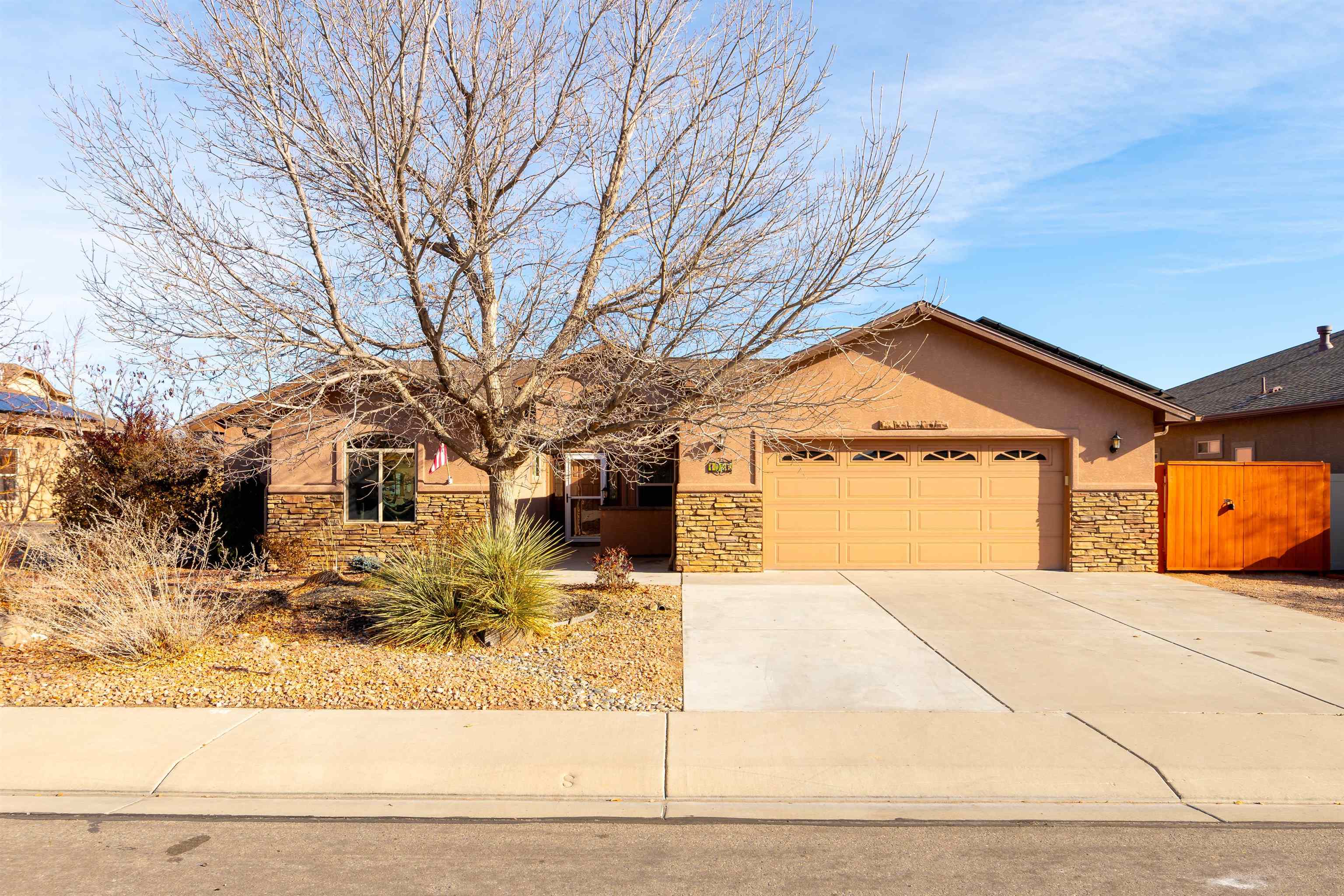 Welcome to Fruita!  This well-maintained home offers the perfect combination of comfort, style and convenience. Step inside to find an open and inviting floor plan featuring solid surface counters, stainless steel appliances and a cozy place to gather with family and friends around the gas log fireplace in the spacious living room. Enjoy the best of indoor-outdoor living with an enclosed, screened-in porch that overlooks the scenic open/green space. Established landscaping, small RV parking area and owned solar offer additional convenience and cost savings. The over-sized three car tandem garage ensures ample storage and extra parking options. Book your private showing today!