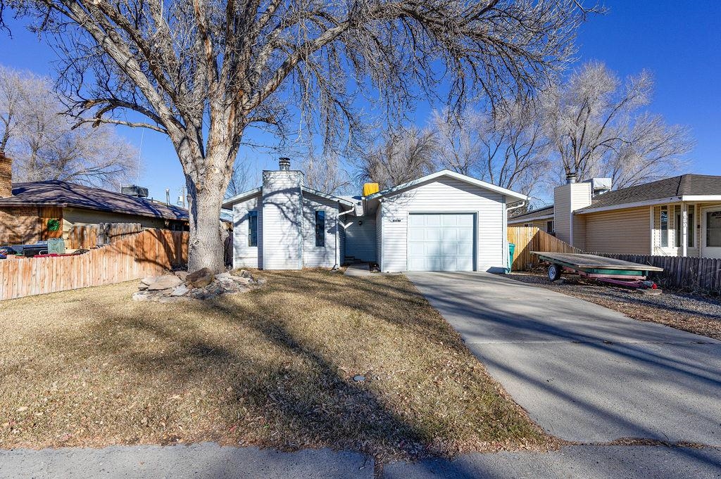 Great home in the heart of Fruita with a large fenced back yard. This 3 bedroom, 2 bath home has a new HVAC unit, new furnace, new LVT flooring, new gutters, new kitchen exterior door, beautiful hickory cabinets, new garage remote, new wifi thermostat and more. You'll love the open and bright living room with a fireplace.  INCLUSIONS: GAS RANGE/OVEN, REFRIGERATOR IN KITCHEN, REFRIGERATOR IN GARAGE, DISHWASHER, GARBAGE DISPOSAL, CHICKEN COOP, SHELVING IN GARAGE