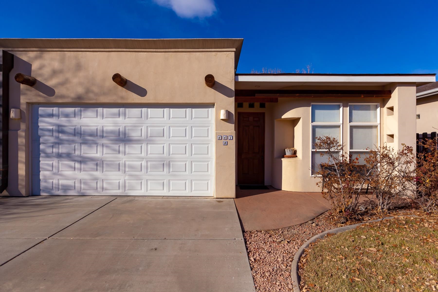 This lovely well maintained Townhome is located in the North Area with proximity to shopping and dining. 3 Bedrooms, 2 baths, 2 car garage and central air.  This home boasts stained concrete flooring throughout and concrete counters.  Architectural features include Hand Hewn Beam Accents, rounded walls and built in shelving.  Many transom windows bring in lots of light!  A corner gas fireplace with tile surround adds to the ambience.  The kitchen boasts stainless appliances, a raised kitchen bar and a large pantry.  Irrigation water is a plus, with a perfectly sized low maintenance yard.  Perfect home to make your own! Set up your showing today!