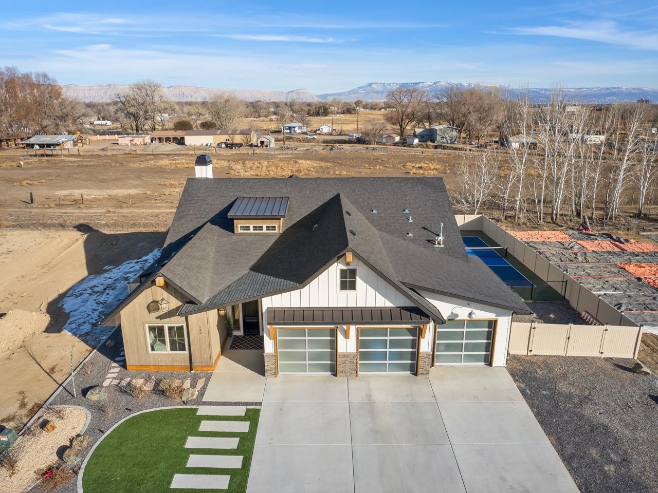 Ready for where the height of luxury meets entertainment? Drumroll please - welcome to Captains Way located in the North area of Grand Junction! Nestled in the peaceful Silver Spur neighborhood in North Grand Junction, this recently built home is an absolute stunner, both inside and out. From the moment you arrive, you’ll be captivated by the sleek, modern exterior, perfectly complemented by a xeriscaped front yard that’s as low-maintenance as it is pleasing. And did we mention the oversized three-car garage? It’s practically made for your car collection (or storage needs). Step inside and be wowed by the open-concept layout with soaring cathedral ceilings and flawless finishes and fixtures throughout. The kitchen is THEE place to entertain, with gleaming quartz countertops, a sit-up bar for casual hangouts, and a wet bar for those festive nights. Stainless steel appliances? Check. Enough space to make any culinary adventure a success? Double check! The spacious living room flows seamlessly into the informal dining room, where a stone lodge-style gas fireplace sets the perfect ambiance. And, just off the main area, you’ll find large, stylish bedrooms and a gorgeous three-quarter bath with a walk-in shower. But hold up… it’s time for a big reveal - the primary bedroom. This is a big one! With easy access to the patio, an abundance of natural light, and a vast walk-in closet this is your ideal retreat. The en-suite bathroom? Chef’s kiss. A luxurious five-piece setup featuring a dual vanity, a deep soaking tub, and a spacious walk-in shower with a seat for all your post-scrub lounging needs. Now, let’s talk backyard bliss. If you’ve ever dreamed of an outdoor space that’s as fun as it is relaxing, this is your chance. Fans of America’s fastest growing sport will rejoice as you’ll have your very own pickleball court! Soak in the heated in-ground pool, and let your worries float away. And when you’re ready to just sit back and take it all in, the back patio offers the perfect setting for enjoying the beauty of your surroundings. This is not just a home; it’s a lifestyle. Don’t sleep on it - schedule your tour of this spectacular property today!