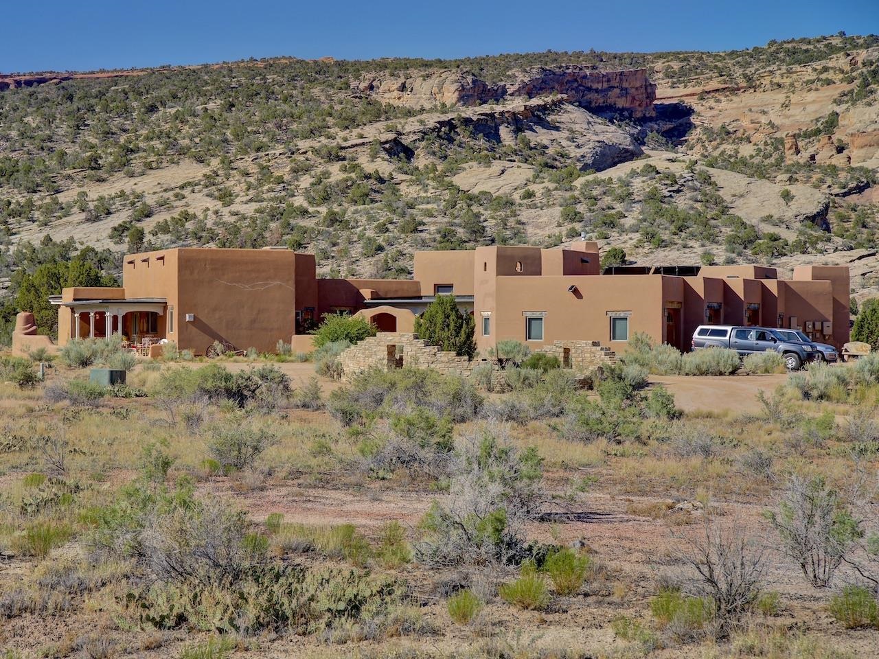 Discover Echo Canyon Ranch, an extraordinary 79.96-acre sanctuary nestled in one of the most coveted locations on Colorado's Western Slope. This exceptional property offers a rare blend of secluded tranquility and convenient access to outdoor recreation and urban amenities. Bordered by the majestic Colorado National Monument and vast BLM lands, Echo Canyon Ranch presents unparalleled privacy and breathtaking panoramic views that stretch across some of the most stunning landscapes in the United States. The heart of this remarkable property is a custom-designed adobe block home crafted by renowned architect Mark Chalom. This architectural masterpiece seamlessly integrates timeless design principles with cutting-edge, eco-friendly technology, resulting in a truly efficient and sustainable living environment. The home's primary heating and cooling source is its ingenious passive solar design, harnessing the power of the sun for year-round comfort. Supplemental heating is provided by a horizontal geothermal loop connected to an in-floor radiant loop system, along with two charming gas stoves.  Two Breeze-Air coolers provide supplemental cooling during the warmer months. Echo Canyon Ranch is a haven for wildlife, where you can observe a diverse array of creatures in their natural habitat. The property's expansive acreage and proximity to protected lands ensure a peaceful and private setting, allowing you to fully immerse yourself in the tranquility of the surrounding wilderness.  Despite its secluded ambiance, Echo Canyon Ranch is just minutes away from a wealth of recreational opportunities, including world-class hiking and mountain biking trails. Downtown Grand Junction, with its vibrant arts scene, dining, and shopping, is also conveniently close, offering the perfect balance of rural living and urban accessibility. This is a once-in-a-lifetime opportunity to own a piece of Colorado paradise.  Don't miss your chance to experience the unparalleled beauty and serenity of Echo Canyon Ranch. Schedule your private showing today!