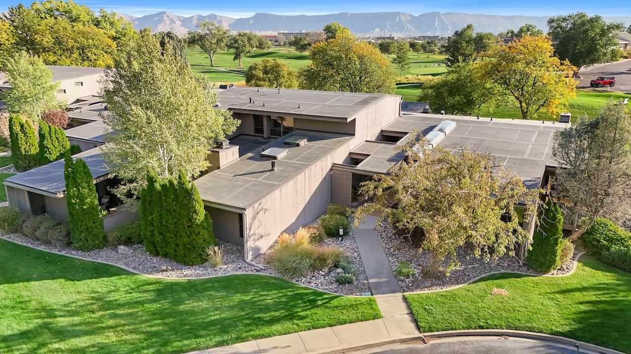 Welcome to this beautiful Mid-Century style home by award-winning designer John Porter. Nestled in the prestigious North area of Grand Junction, and just steps from the 1st hole of the Country Club. This home offers natural light with warm intricate details throughout. 3 open patios. Gorgeous kitchen with newer cabinets, appliances, Staron countertops, meticulously modernized. Only steps from the Country Club and majestic views. Just move in and start enjoying life to the fullest.  Monthly HOA fee includes a 30-year savings account for capital improvements.