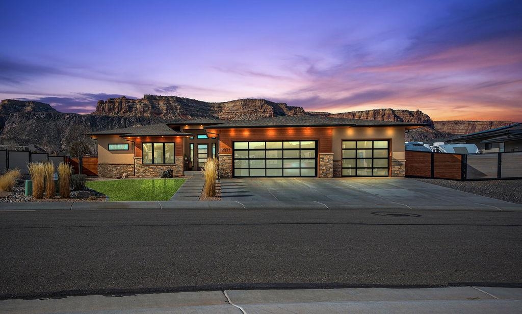 Welcome to this stunning J. Howell Construction custom-built 4-bedroom, 2.5-bathroom home in Granite Falls Subdivision, situated on a spacious .32-acre lot. Enjoy breathtaking views of the Colorado National Monument while you sit next to your gas fireplace on your covered patio. Featuring an oversized 3-car garage with a hot water bib and smart home technology, this home is designed for modern living. The 4th bedroom can also serve as a home office. Enjoy high-end appliances, maple cabinets with under-cabinet lighting, hardwood floors, and a gas log fireplace in the living room. Elegant Hubbardton Forge lighting completes the sophisticated style. A perfect blend of luxury and comfort!