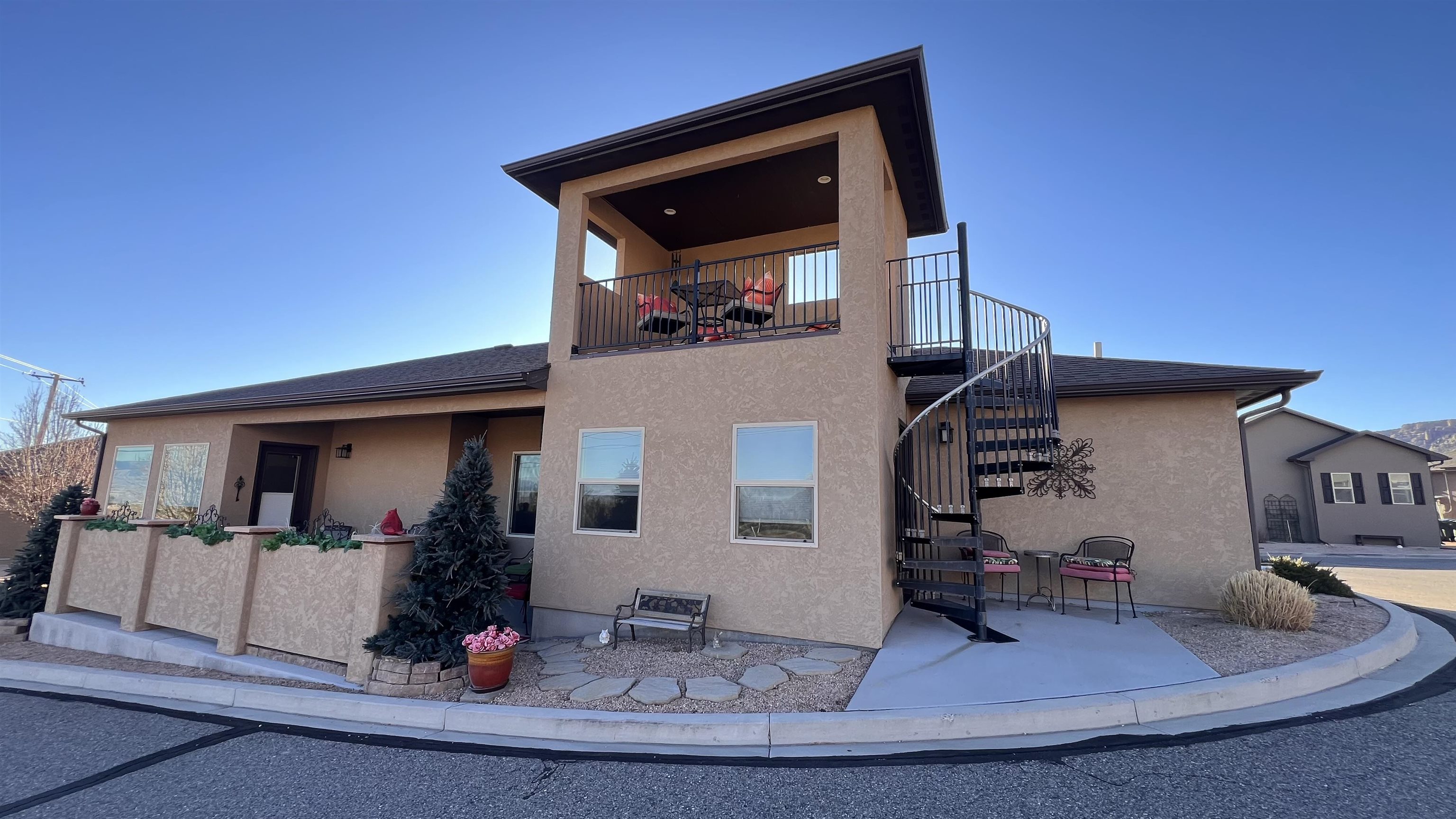 This exceptional home offers the perfect blend of luxury, comfort, and breathtaking surroundings. Nestled next to Tiara Rado Golf Course with stunning views of the Colorado National Monument in addition to 360 views of the valley. The primary suite is a true retreat, featuring a spacious bathroom with dual sinks and two full walk-in closets, double shower and soaker tub.  The beautifully designed kitchen opens to a charming courtyard, perfect for outdoor relaxation. A grand entryway welcomes you inside, while a spiral staircase leads to a unique tower space. Additional highlights include a well-equipped laundry room with a utility sink, a bonus room in the garage, and high-end finishes throughout. Immaculately maintained and move-in ready, this home offers unparalleled style, comfort, and scenic beauty.