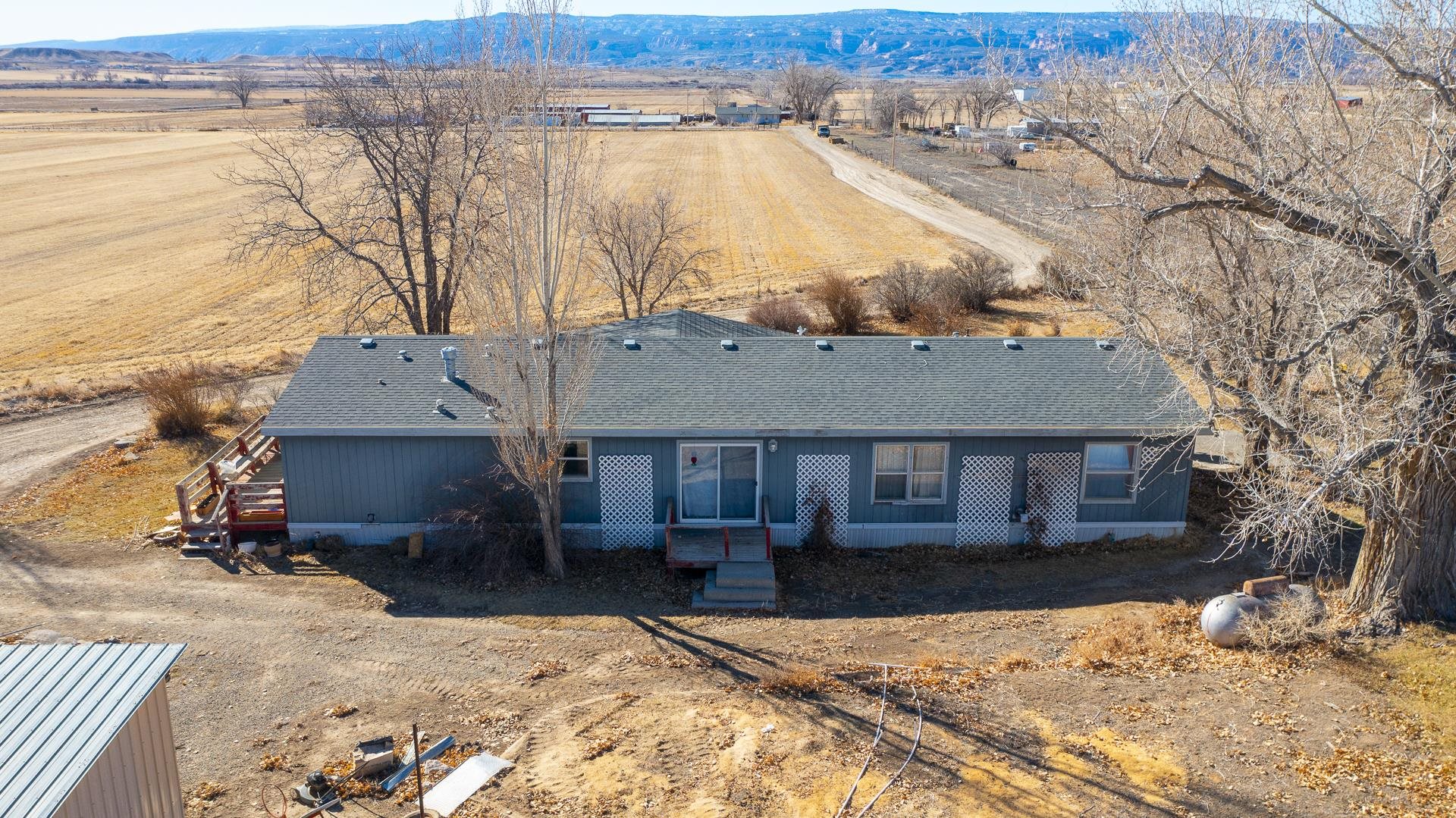 Ready for Farm Life? Here it is! House, outbuildings, shops, animal shelters, multiple granaries, corrals, pasture re-seeded last year, irrigation water, mature trees, decks, patios, views and a private location. Home features 4 bedrooms, 2 baths, living & family rooms, dining room and kitchen with breakfast bar. Plenty of room when neighbors or family stops by. Just minutes to downtown Fruita, or Public lands for 4-Wheeling, horse back riding or just exploring. Property has a lifetime of accumulation and Sellers are working on getting property cleaned up.