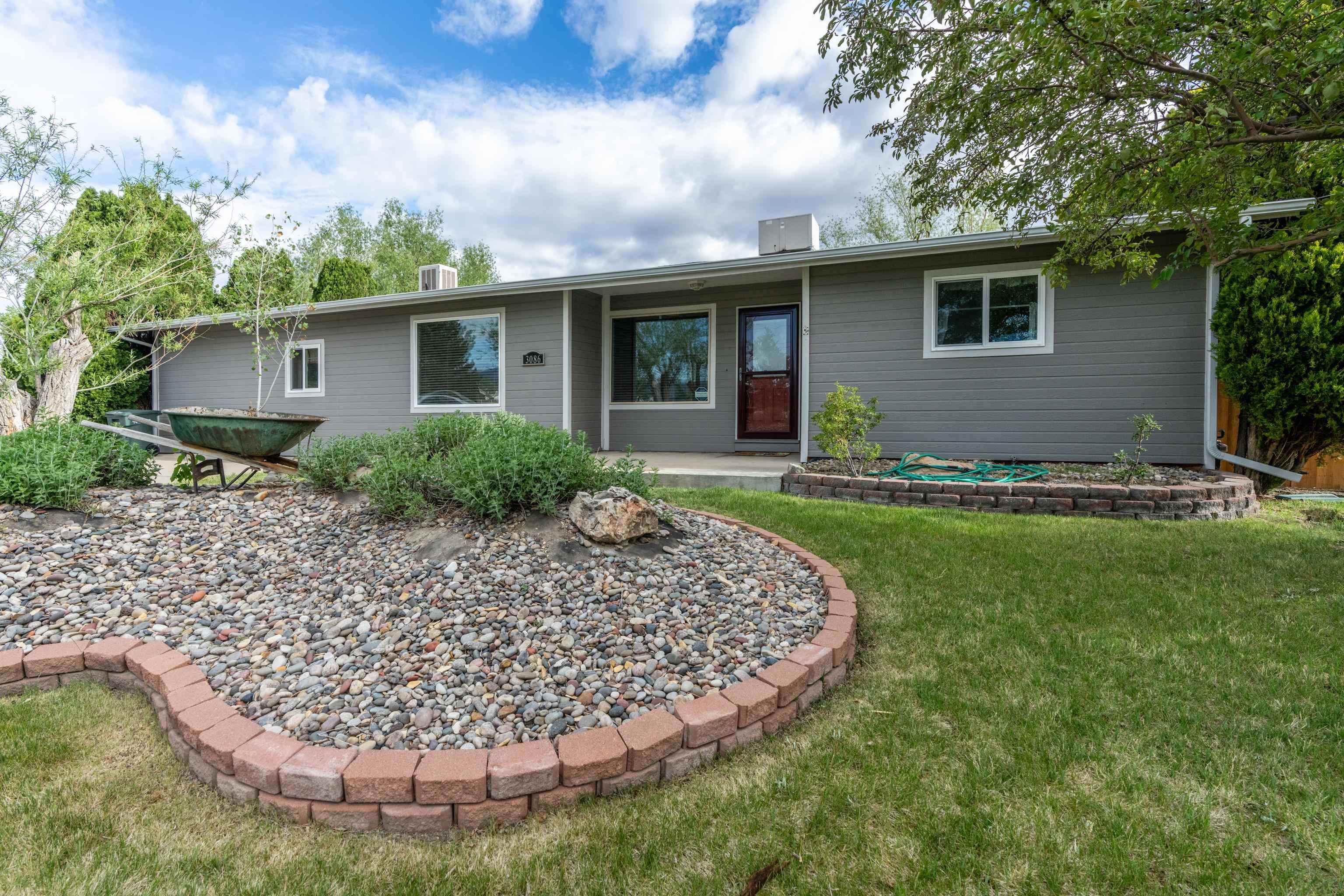 Discover the perfect blend of space, comfort, and convenience! Step inside to find a 3-bedroom, 2-bath home with tongue and groove accents that bring warmth and style. New roof and new exterior paint, updated kitchen cabinets, and vinyl windows complement a spacious 1.47-acre corner lot with 2 shares of irrigation water and mature landscaping. Bring the toys and/or animals to enjoy plenty of RV parking and a deluxe chicken and goat setup. The split floor plan includes a large primary suite, a south-facing cozy living room and a heated/cooled detached bonus room perfect for creative pursuits or working from home. Also potential for an Accessory Dwelling Unit (ADU) or subdividing. Country living just 10 minutes to downtown and 1 mile to school and Colorado River Trail system!