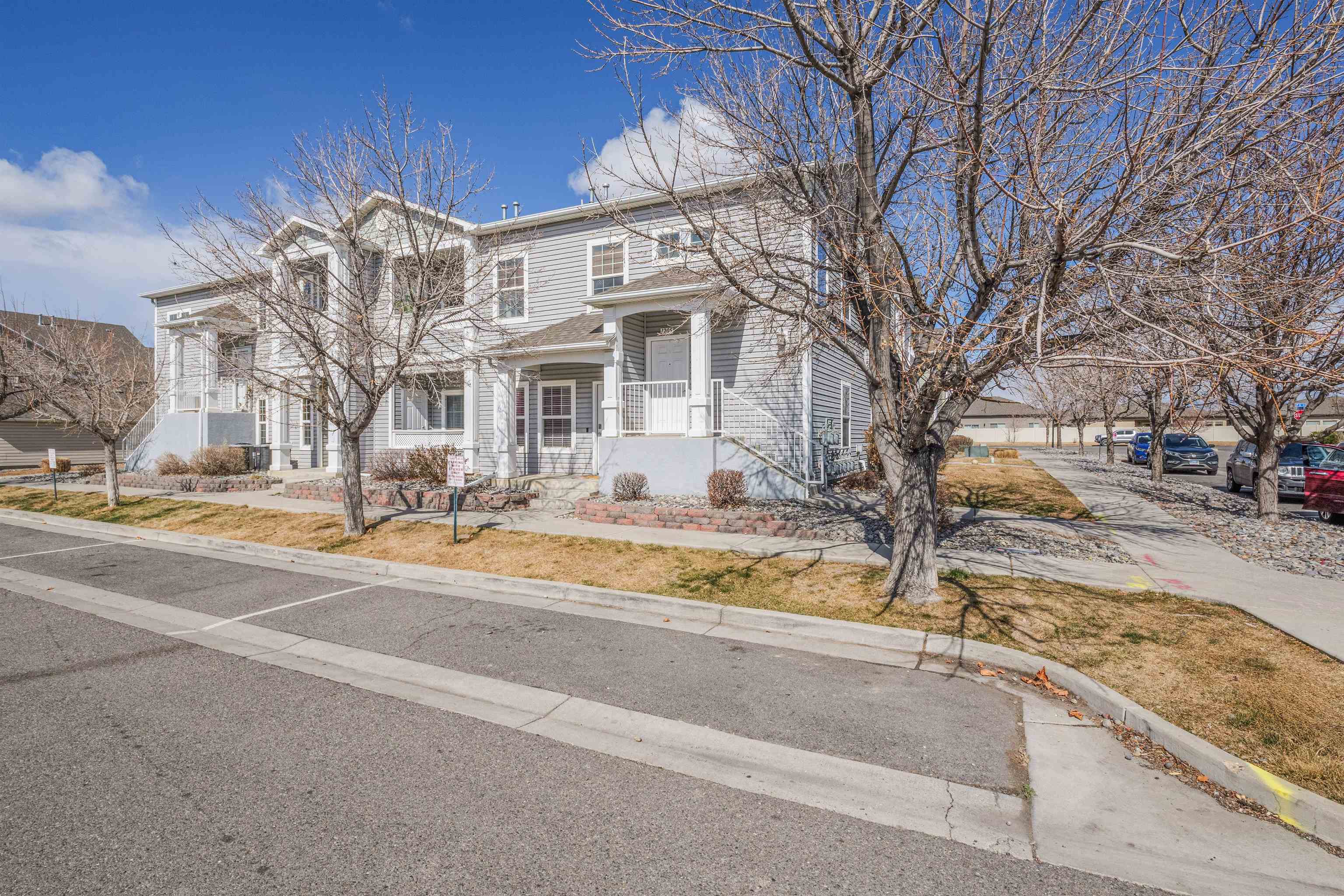 Welcome to this well maintained second-level 3-bedroom, 2-bath condo in the heart of Grand Junction, convenient to public transit and shopping.  The neighborhood is quiet and has tree lined streets. This bright and airy home features vaulted ceilings, abundant natural light, and vinyl flooring throughout. The open-concept design includes a spacious kitchen with a pantry and a generous living area perfect for entertaining. The split-bedroom layout offers privacy, with the primary bedroom featuring an ensuite bathroom and walk-in closet. Enjoy a private balcony with views of Watertank & the Colorado National Monument. The unit comes with a storage closet plus a detached single car garage. An American Standard central air unit, microwave, & garbage disposal were all replaced in 2025, and dishwasher in 2023. In-unit washer and dryer add to the ease of living, and a well-managed HOA takes care of landscaping, making this a perfect lock-and-leave home. Be proud to show this beautiful property—schedule a tour today!