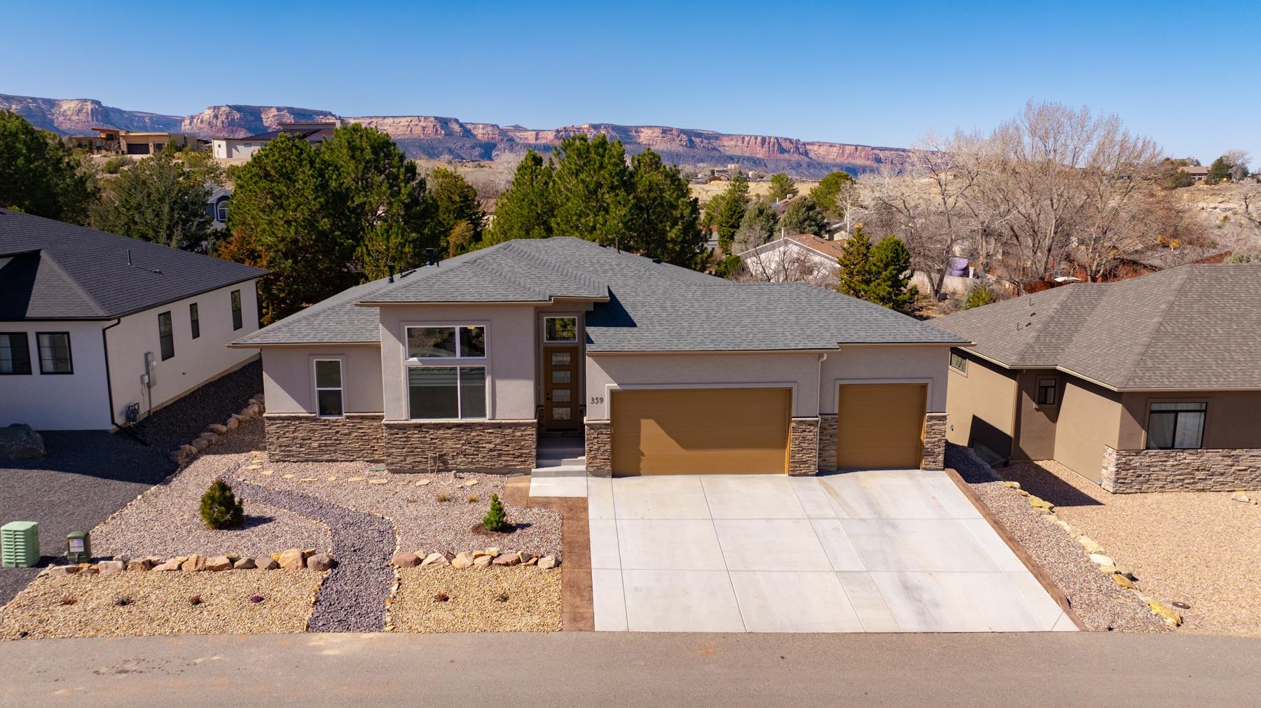 You need to see this exceptional Redlands home in Pinnacle Ridge Subdivision. Beautifully completed and better than new with stunning finishes, window coverings, and landscaping. Enjoy a gas fireplace in the great room, access out to the gorgeous patio, large kitchen island with a breakfast bar and windows to take in the area views. The floor plan features a great use of space. Primary and secondary bedroom/office are on the main level. The tile work is amazing! There are 2 more bedrooms, full bath, and a family room on the lower level in the walk-out basement with doors going out to another covered patio with a hot tub, putting greens, and water feature. The landscaping is low maintenance and the 3 car garage has a lot of storage space. The location is fantastic with outdoor recreation right out your front door including hiking, biking, and golf.