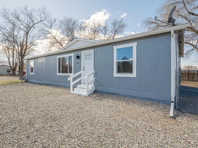 Discover affordable comfort in this completely renovated 3-bedroom, 2 full bath manufactured home, perfectly situated on its own lot—no lot rent! Nestled in a convenient location within walking distance to downtown Fruita, parks, schools and trail system, this home offers the best of both worlds: convenience and affordability. Inside, you'll find a split bedroom design, vaulted ceilings, open concept living area with plenty of natural light, a well-equipped kitchen with and all new appliances and a butcher block breakfast bar.  The private primary suite features plenty of closet space, a private en-suite bath and a separate vanity area.  There are 2 additional bedrooms perfectly suited for guests or additional family members.  The large, fully fenced corner lot provides space for gardening, entertaining, or simply relaxing.  This lot also has room to build a garage or an ADU.  With off-street parking and a welcoming atmosphere, this property is an excellent opportunity for homeowners and investors alike! Don't miss out—schedule your showing today!