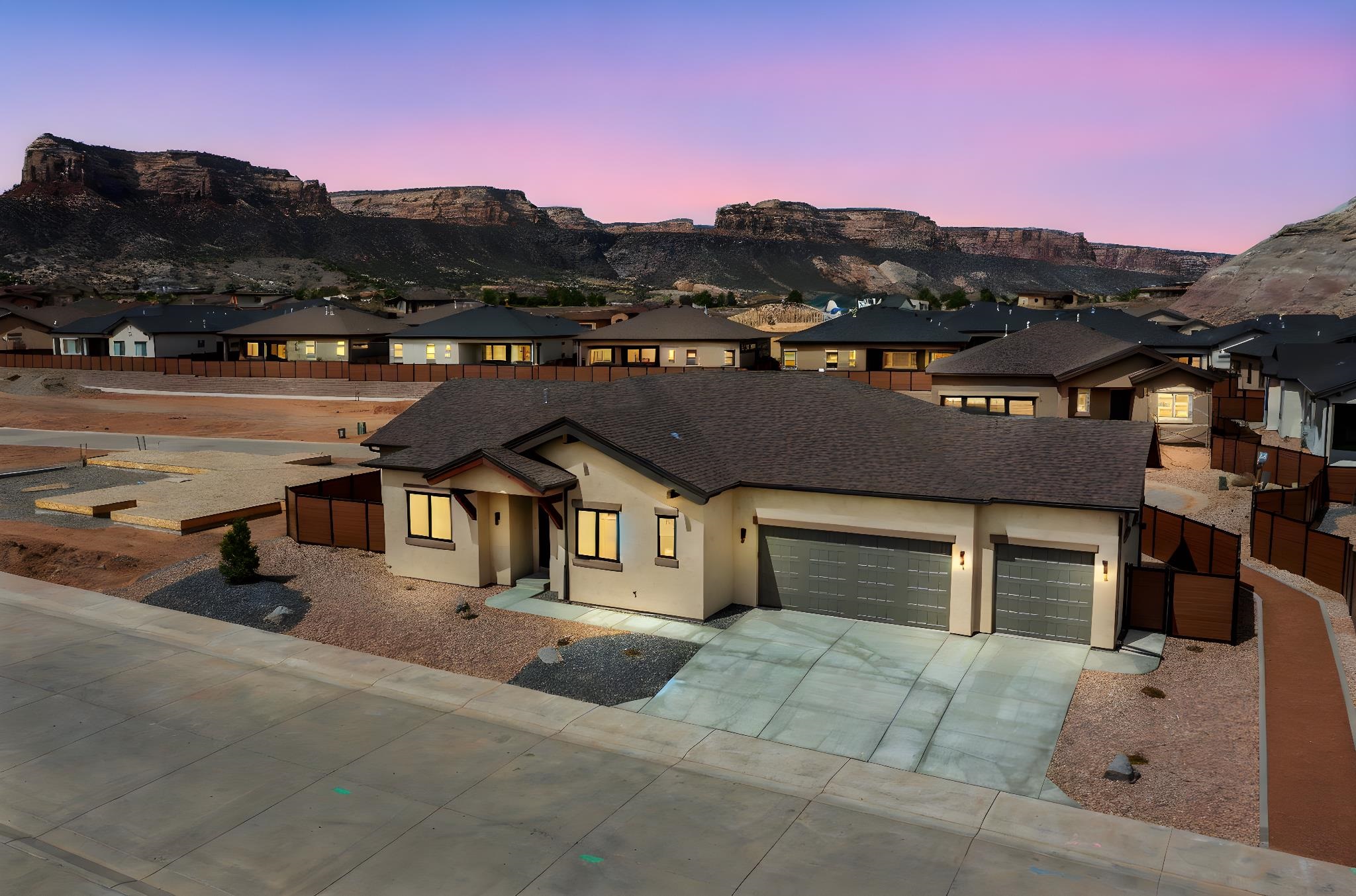 Beautiful brand new construction by Conquest Construction in Red Rocks Valley! Home features 3 bedrooms 3 bathrooms and 3 car garage. Primary suite includes a function office/study space attached. Fully fenced and low water desert landscaping with views of the Monument. As you walk through the home you will love the wood beam detail, functional entry and ample storage throughout the home.  Open floor plan of kitchen, dining and great room lead you right out onto covered patio with a fantastic yard for entertaining. Located in the Redlands this property is in the center of hiking, biking and golf. Near the base of the Colorado National Monument with unbelievable views!