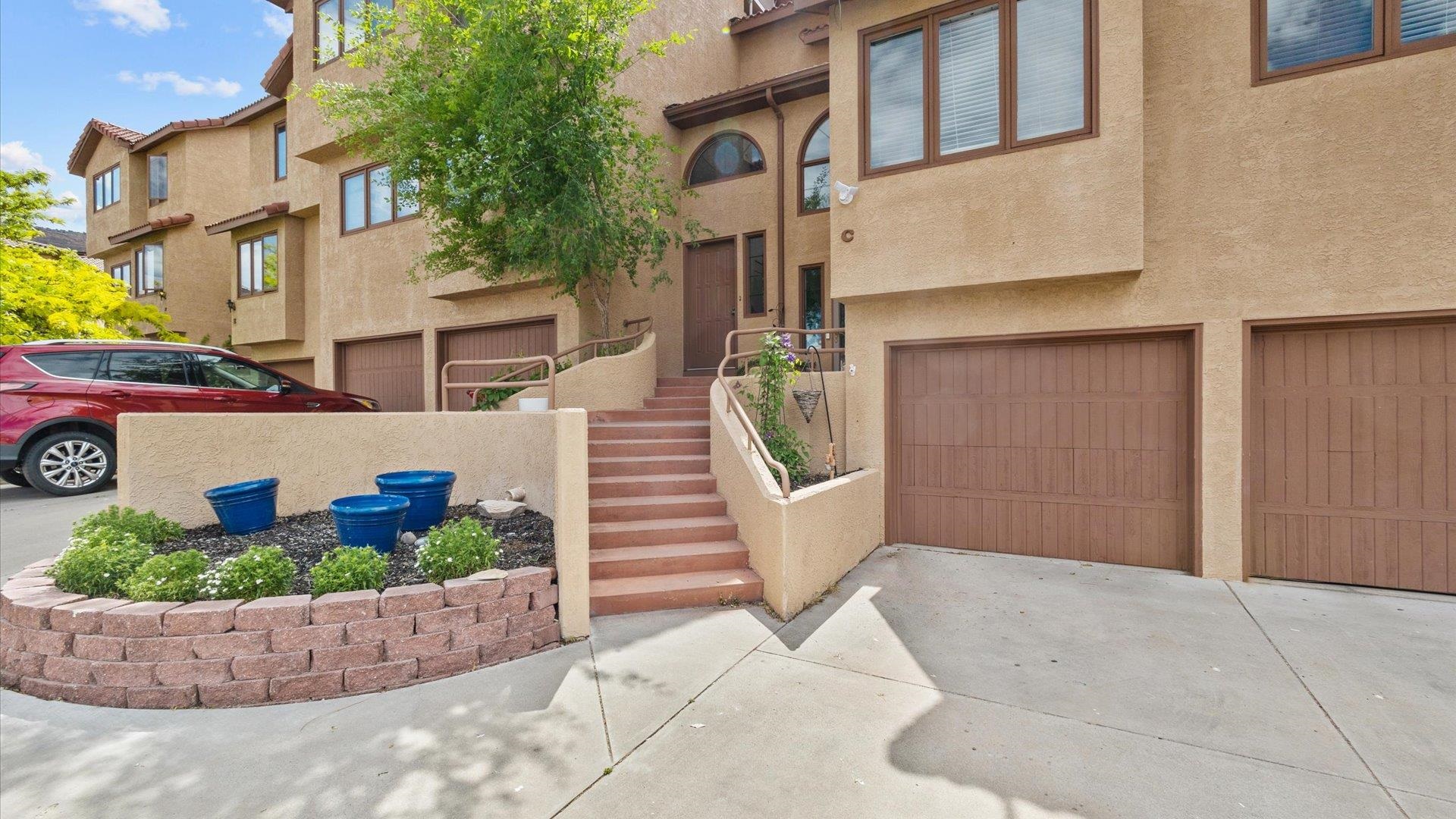 is is the one!  Unbeatable location? Absolutely. Just steps from the renowned Tiara Rado Golf Course and a quick drive to a local winery, this home also offers easy access to not one, but two entrances to the Colorado National Monument. With scenic trails, walking paths, and bike routes all nearby—including the famed Lunch Loops Mountain Biking area just 10 minutes away—adventure is always close by.  Or maybe it's the breathtaking views that win you over. From your own private patio, watch the sun set behind the Monument’s iconic red rock cliffs—pure Colorado magic.  Prefer a low-maintenance lifestyle? You’re covered. This lock-and-leave home comes with an HOA that handles the hard work, giving you more time to relax and explore.  Inside, this three story home is the remodeled kitchen features butcher block countertops and open shelving—perfect for both cooking and entertaining. The primary suite includes a large, tiled walk-in shower with heated flooring and a beautifully updated walk-in closet to streamline your mornings.  The spacious living room with its cozy gas fireplace invites you to unwind, while a large bonus room/office in the basement—just off the garage—offers the flexibility to live, work, or play in comfort.  And speaking of the garage: there’s plenty of room for two cars and all your gear—golf clubs, bikes, camping supplies, fishing poles—everything you need to make the most of this incredible location.  Come see why this home truly has it all.